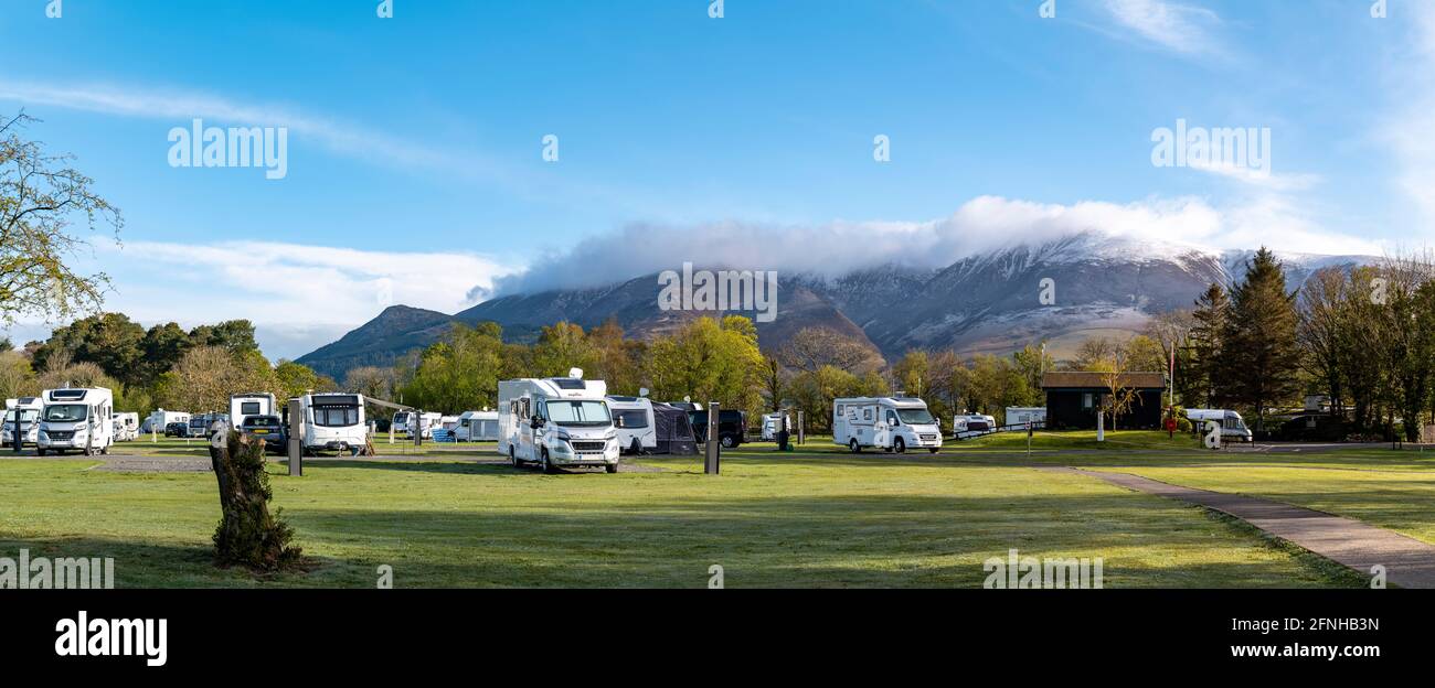 Keswick Caravan and camping club site with a snow capped Skiddaw in the background. An early spring morning as the campsite comes to life. Stock Photo