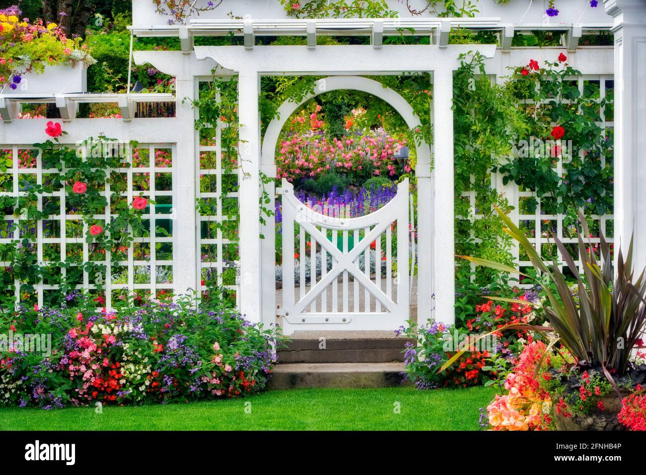 Gate with flowers at Butchart Gardens, B.C. Canada Stock Photo