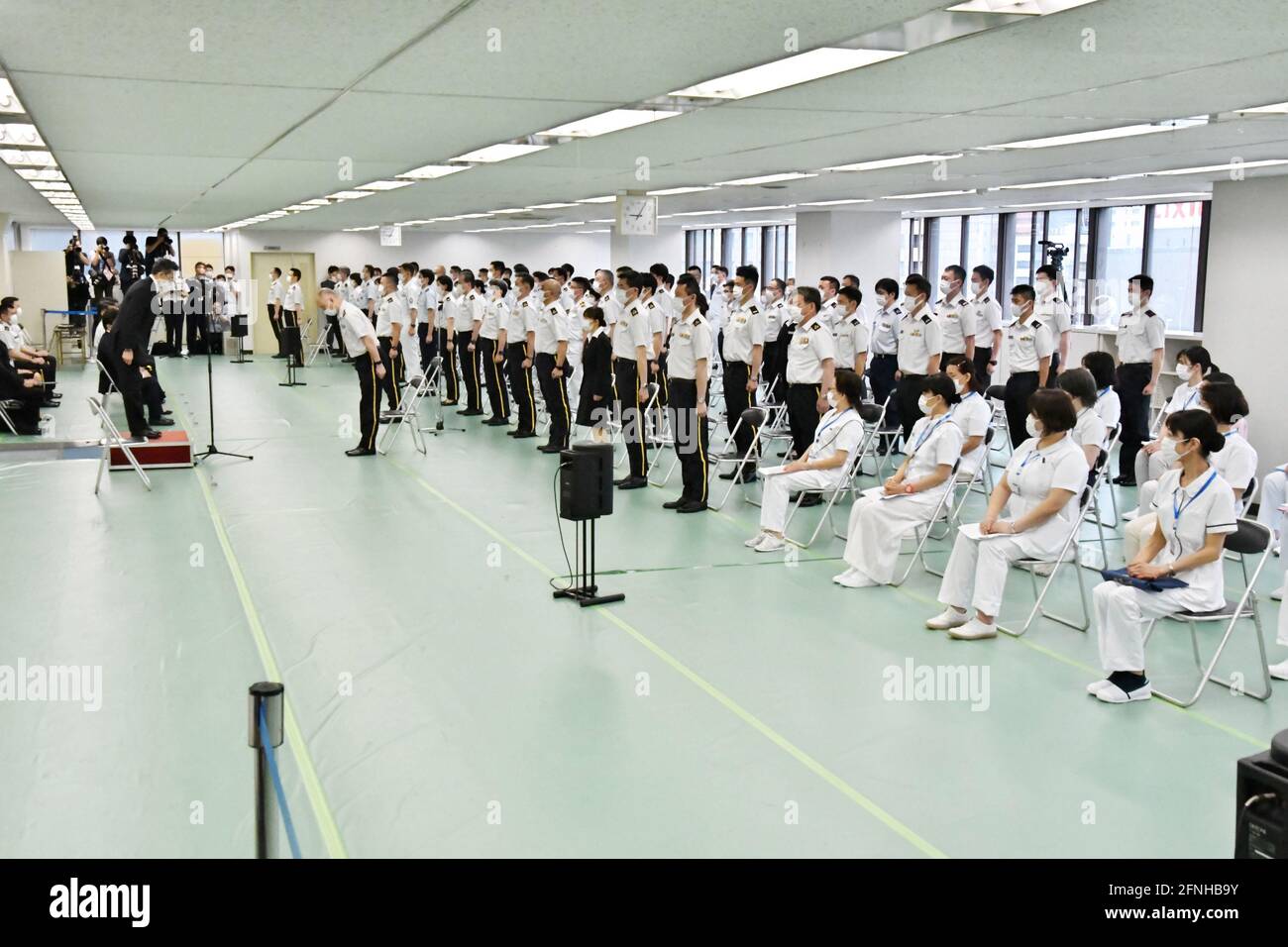 Tokyo, Japan. 17th May, 2021. Japan Self?Defense Forces' officer salute during a launch ceremony for Japan Self?Defense Forces' large-scale Covid-19 vaccination centres in Tokyo, Japan on Monday, May 17, 2021. This centre will open on May 24, 2021. Tokyo operation units organize Ground, Air and Maritime Self?Defense Forces' (Army, Air force and Navy) 240 officer and private 110 medical worker out of 350 members. Photo by Keizo Mori/UPI Credit: UPI/Alamy Live News Stock Photo