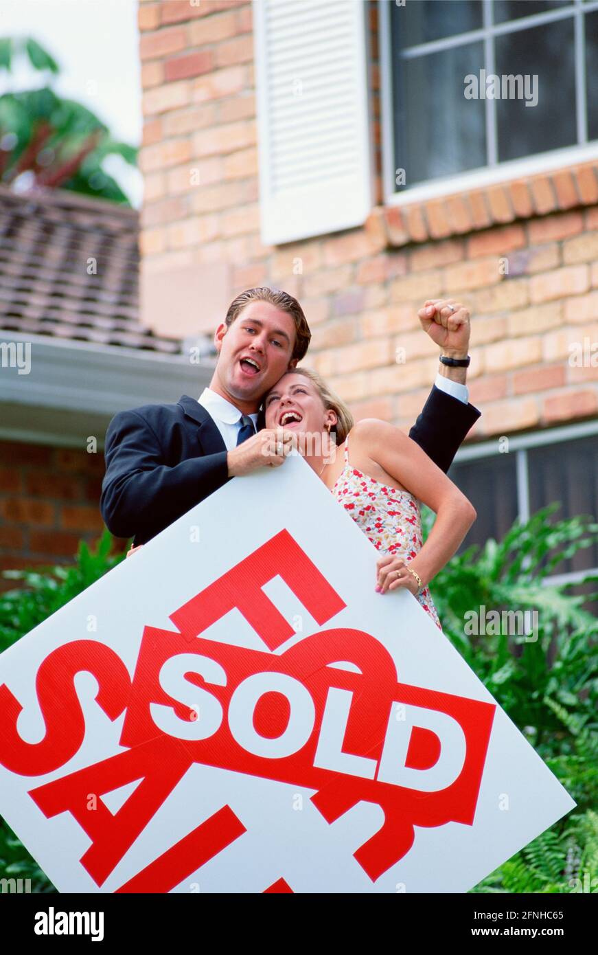 Australia. Lifestyle. Young couple outside newly purchased house. Happy home purchase. Stock Photo