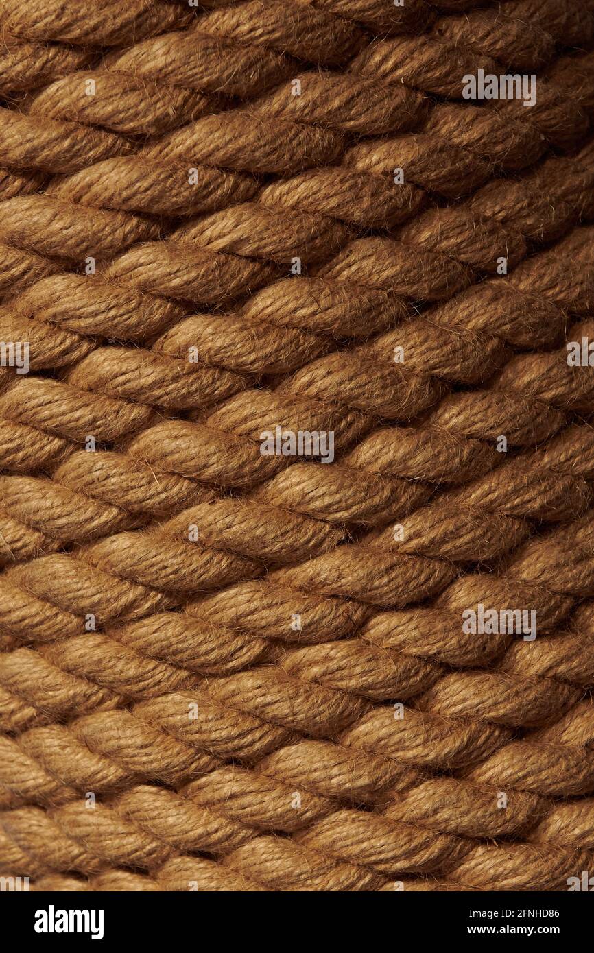 Closeup rope background. Low light brown rope texture. Vertical