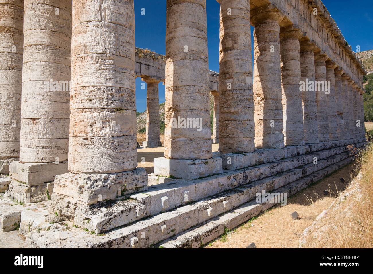 Calatafimi-Segesta, Trapani, Sicily, Italy. Stout stone columns forming part of the 5th century BC Doric temple at the Segesta archaeological site. Stock Photo