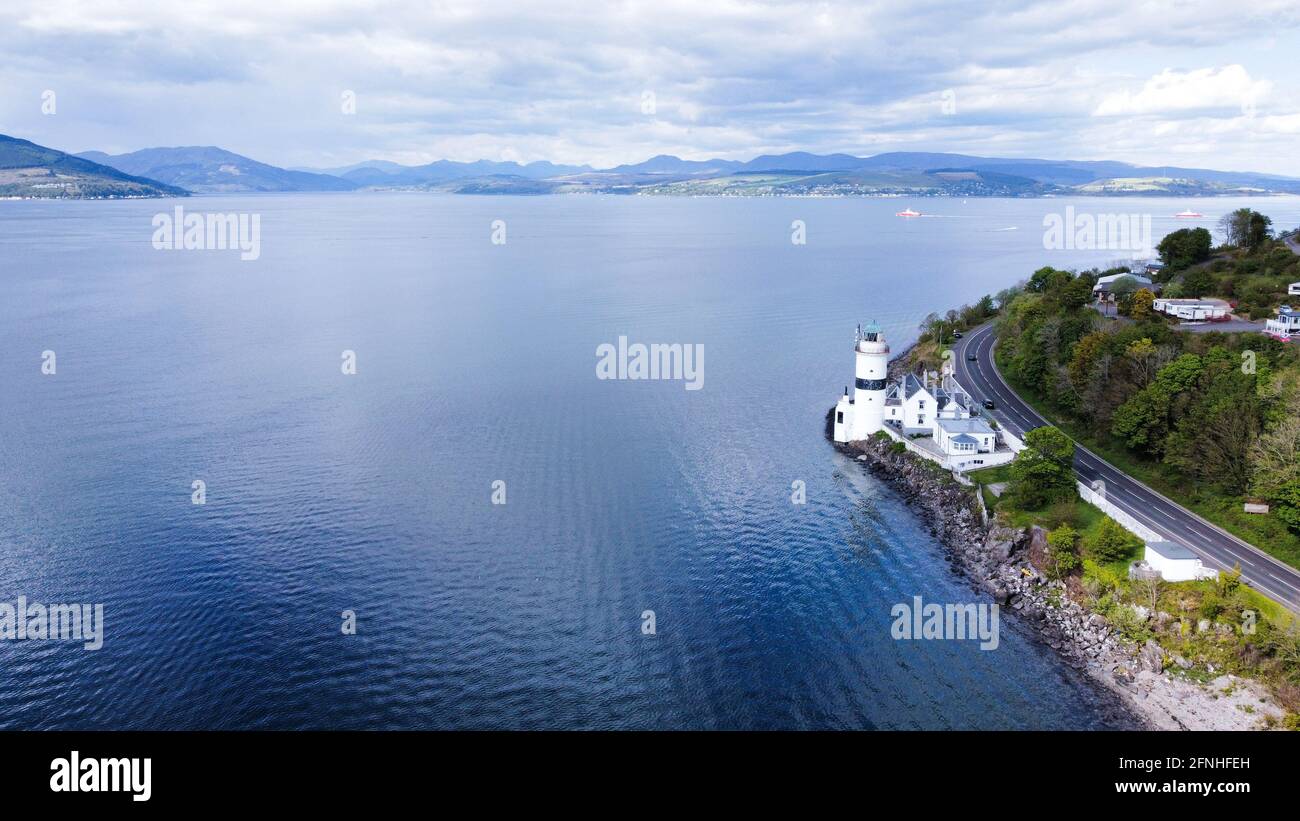 An aerial photo of a Scottish lighthouse. It is minimalist and evokes a sense of freedom and a dynamism between a shared past, present and future. Stock Photo