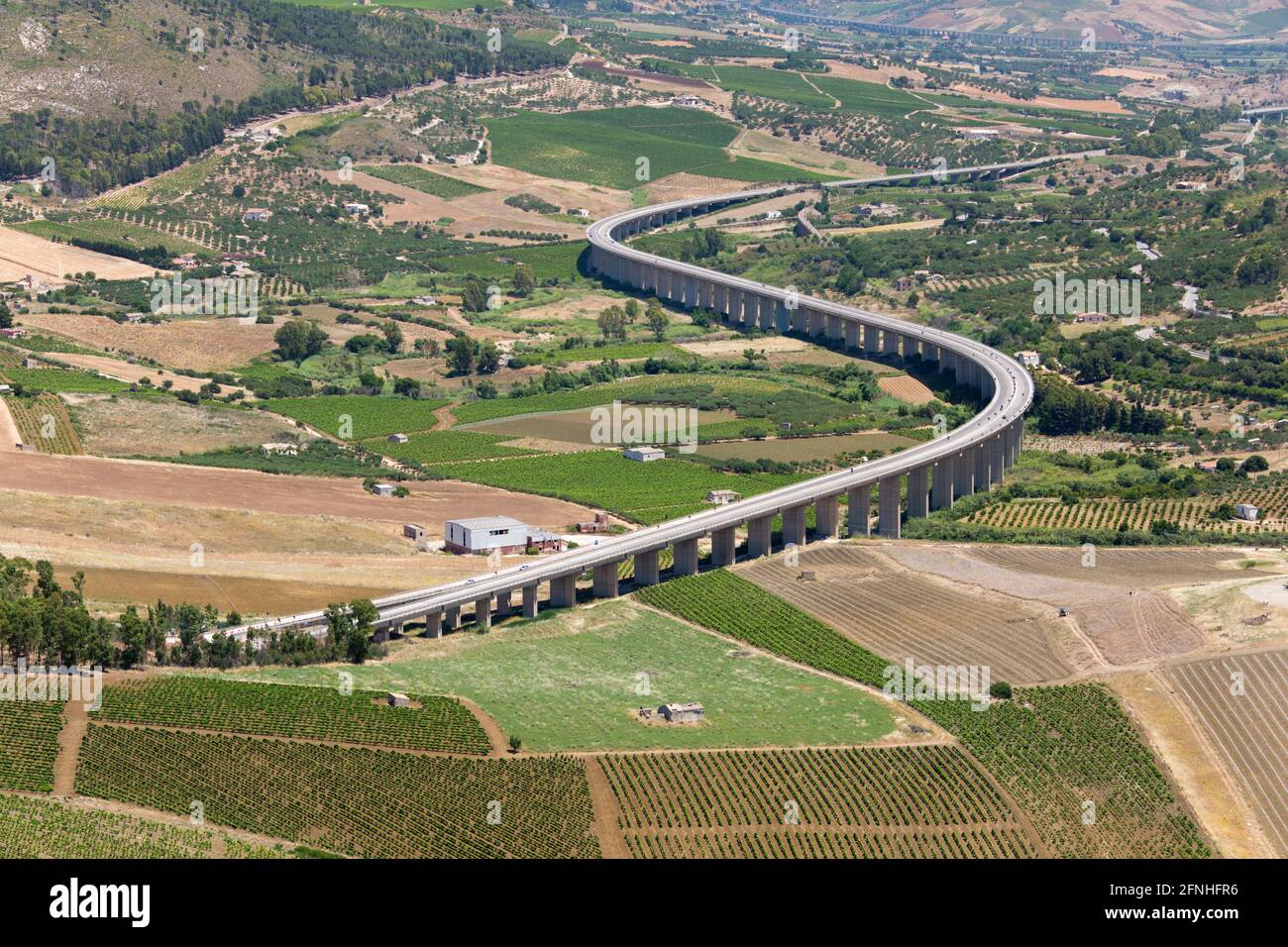 Calatafimi-Segesta, Trapani, Sicily, Italy. Suspended motorway winding across attractive farmland below Monte Bàrbaro, Segesta archaeological site. Stock Photo
