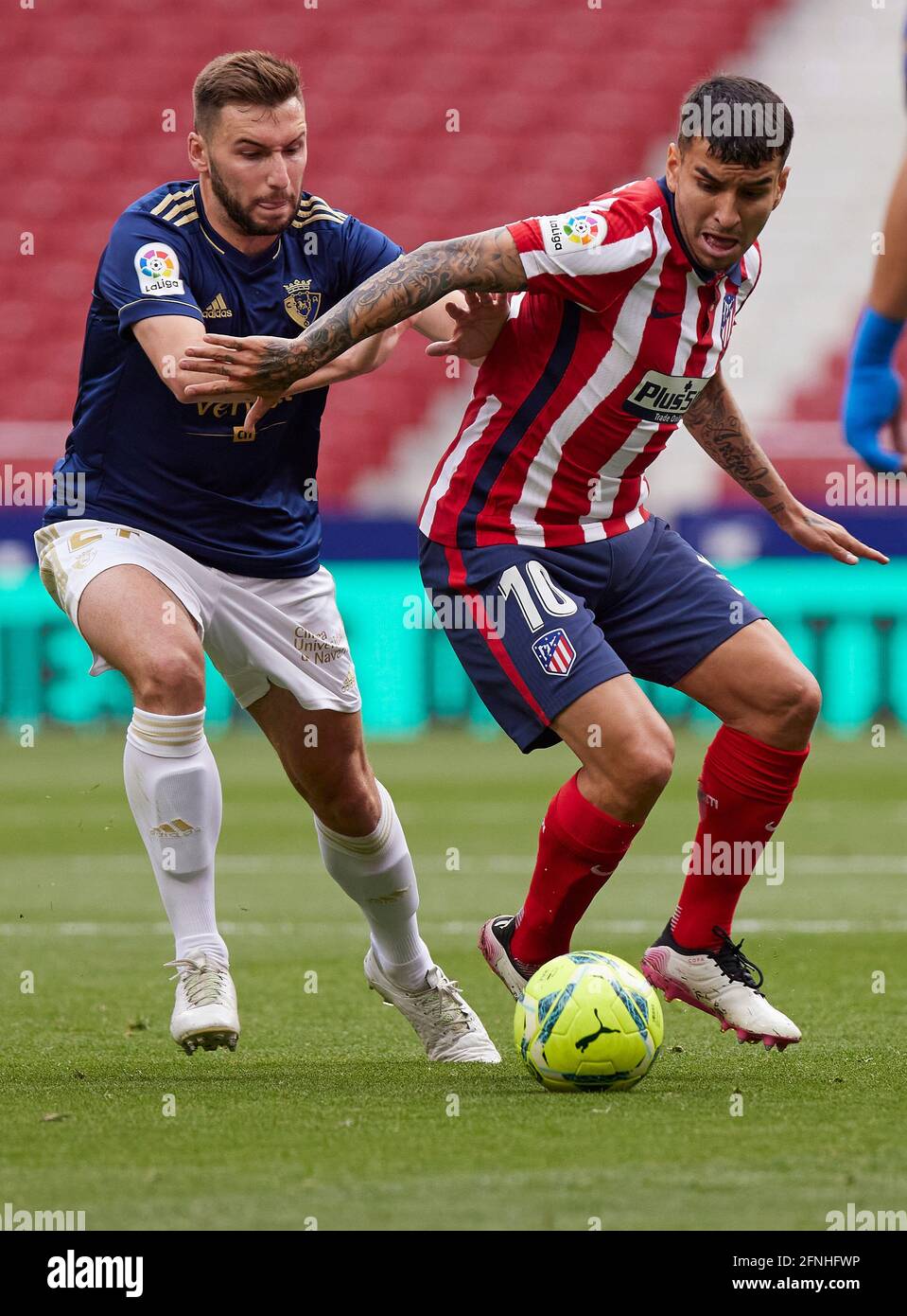 Angel Correa (Atletico de Madrid) and Lucas Torro (CA Osasuna) battle for the ball during the La Liga match round 36 between Atletico Madrid and CA Osasuna at Wanda Metropolitano Stadium.Sporting stadiums around Spain remain under strict restrictions due to the Coronavirus Pandemic as Government social distancing laws prohibit fans inside venues resulting in games being played behind closed doors. Final score; Atletico Madrid 2:1 CA Osasuna. Stock Photo