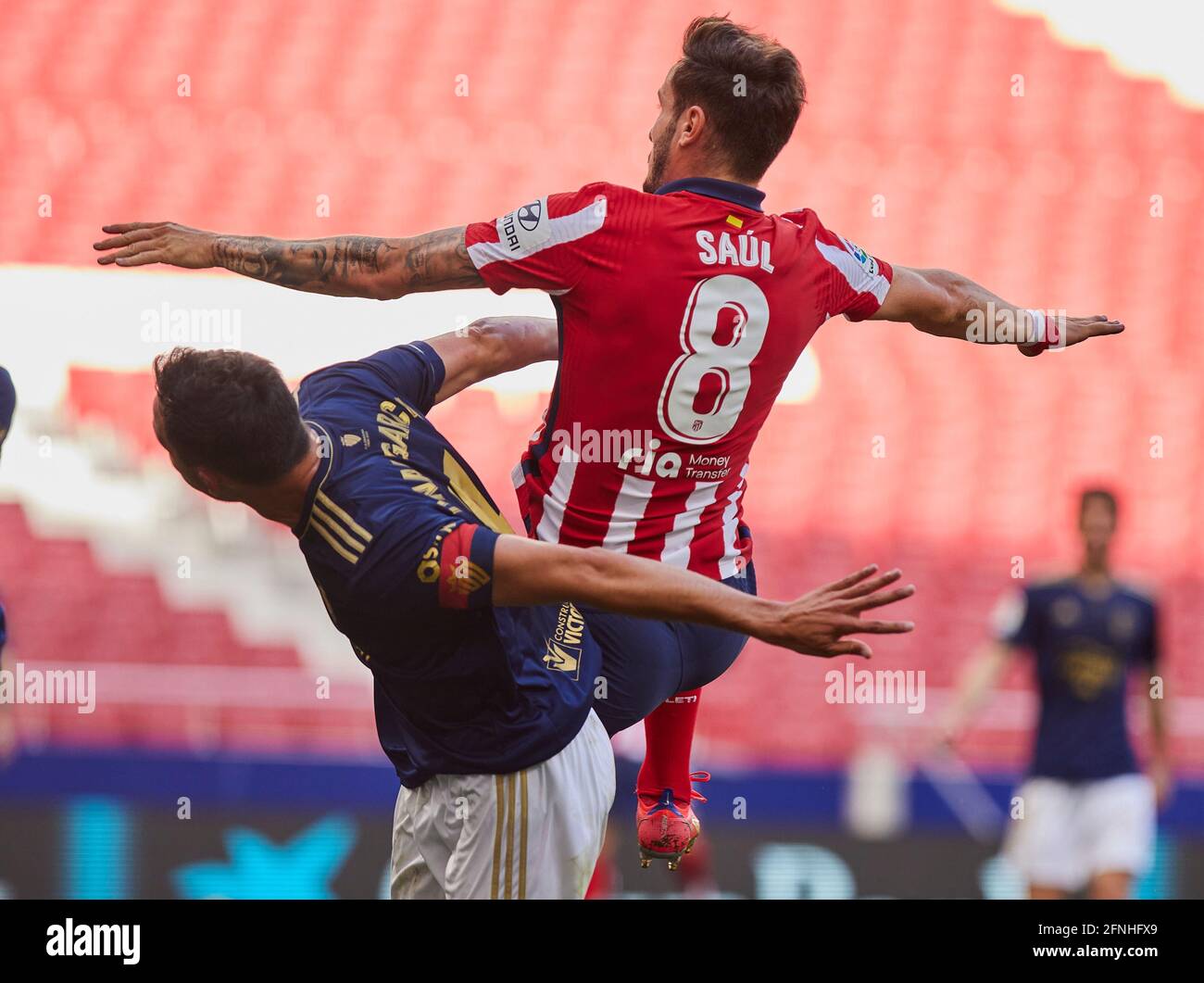 Unai Garcia (CA Osasuna) and Saúl Ñíguez (Atletico de Madrid) in action during the La Liga match round 36 between Atletico Madrid and CA Osasuna at Wanda Metropolitano Stadium.Sporting stadiums around Spain remain under strict restrictions due to the Coronavirus Pandemic as Government social distancing laws prohibit fans inside venues resulting in games being played behind closed doors. Final score; Atletico Madrid 2:1 CA Osasuna. Stock Photo