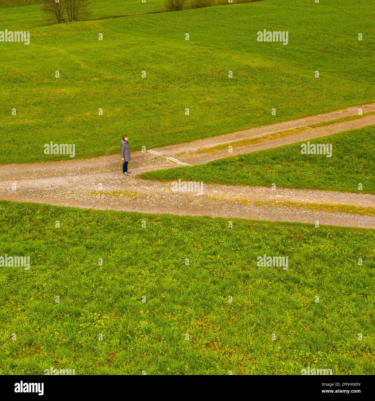 Woman at the crossroads. Aerial view. Stock Photo
