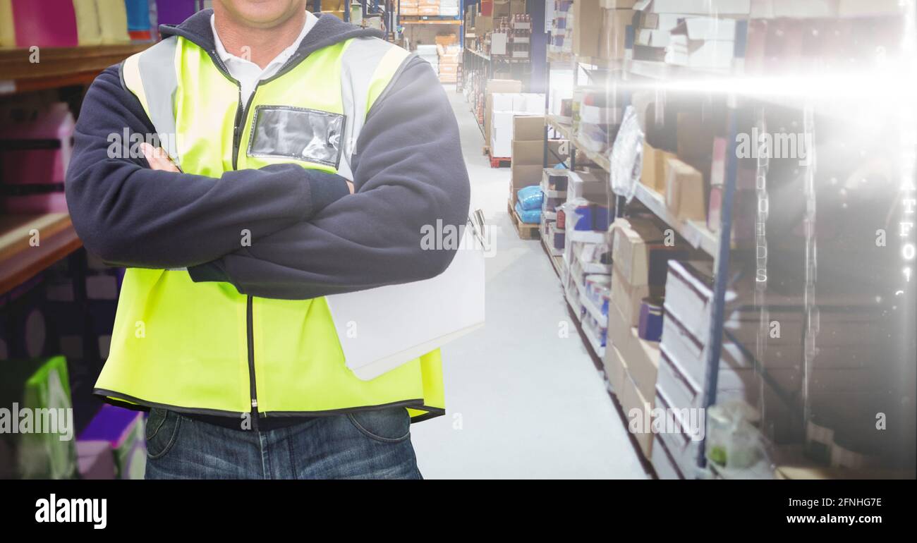 Mid section of caucasian worker crossed arm and wearing yellow vest Stock Photo