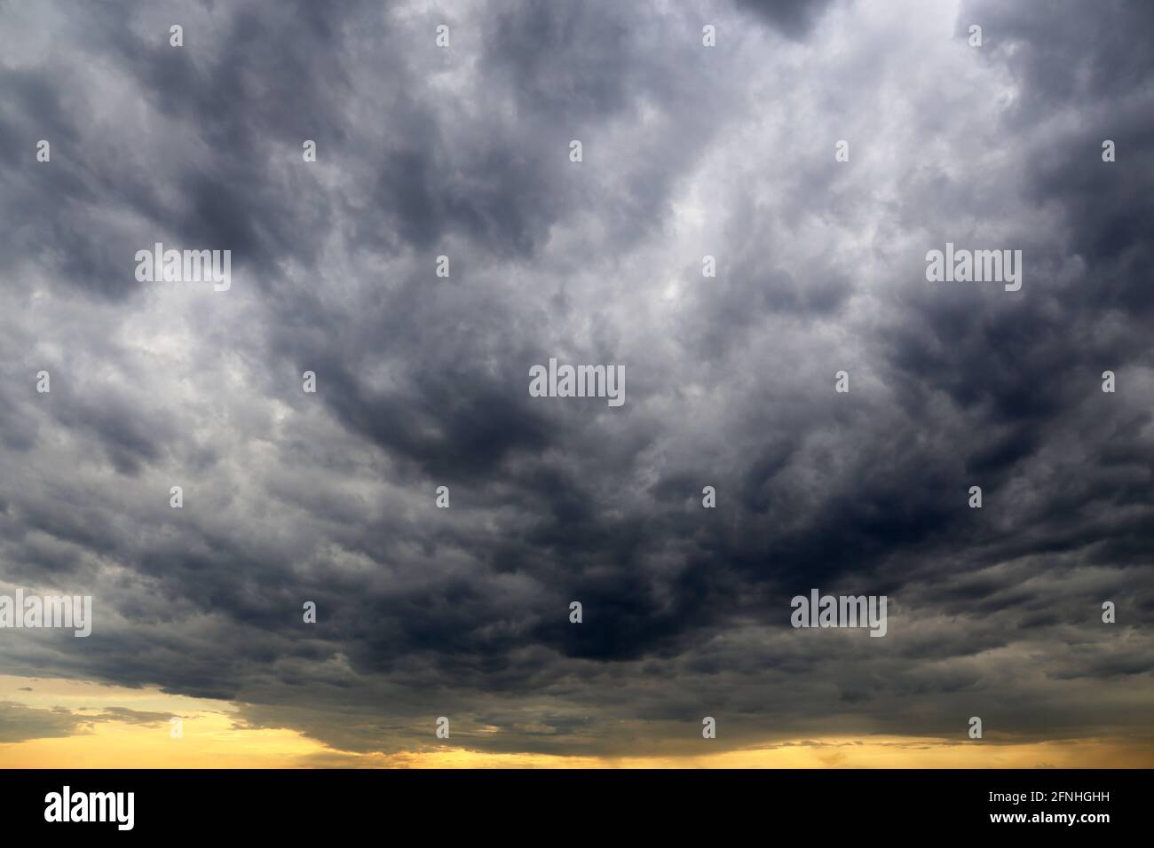 Sky covered with dark storm clouds. Dramatic background for weather before rain Stock Photo