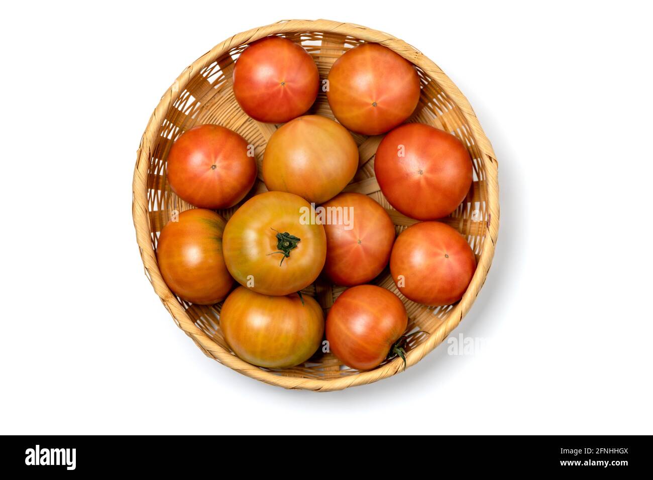 Tomatoes in a basket isolated on white background Stock Photo - Alamy