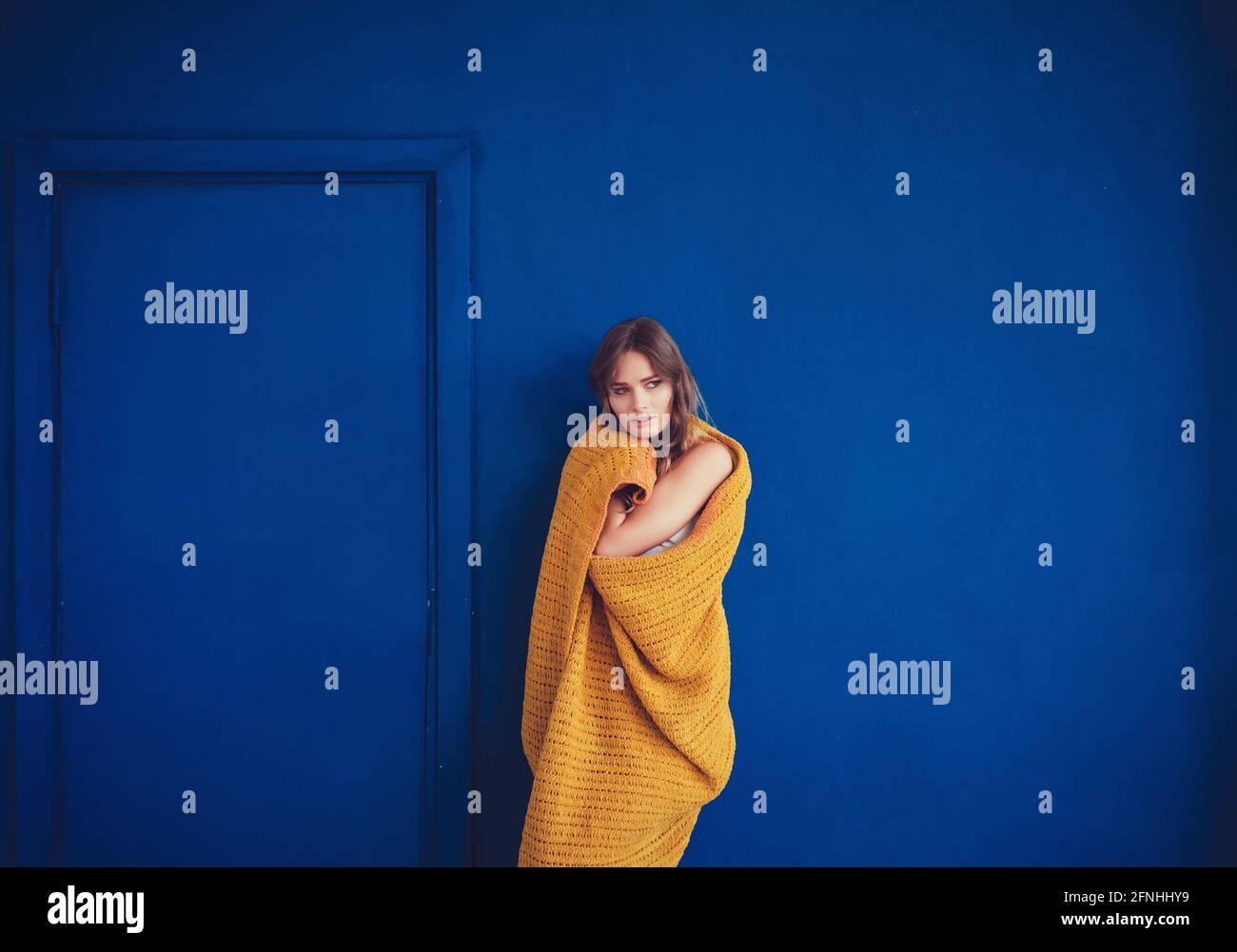 Cozy woman covered with warm soft wool blanket. Relax, comfort