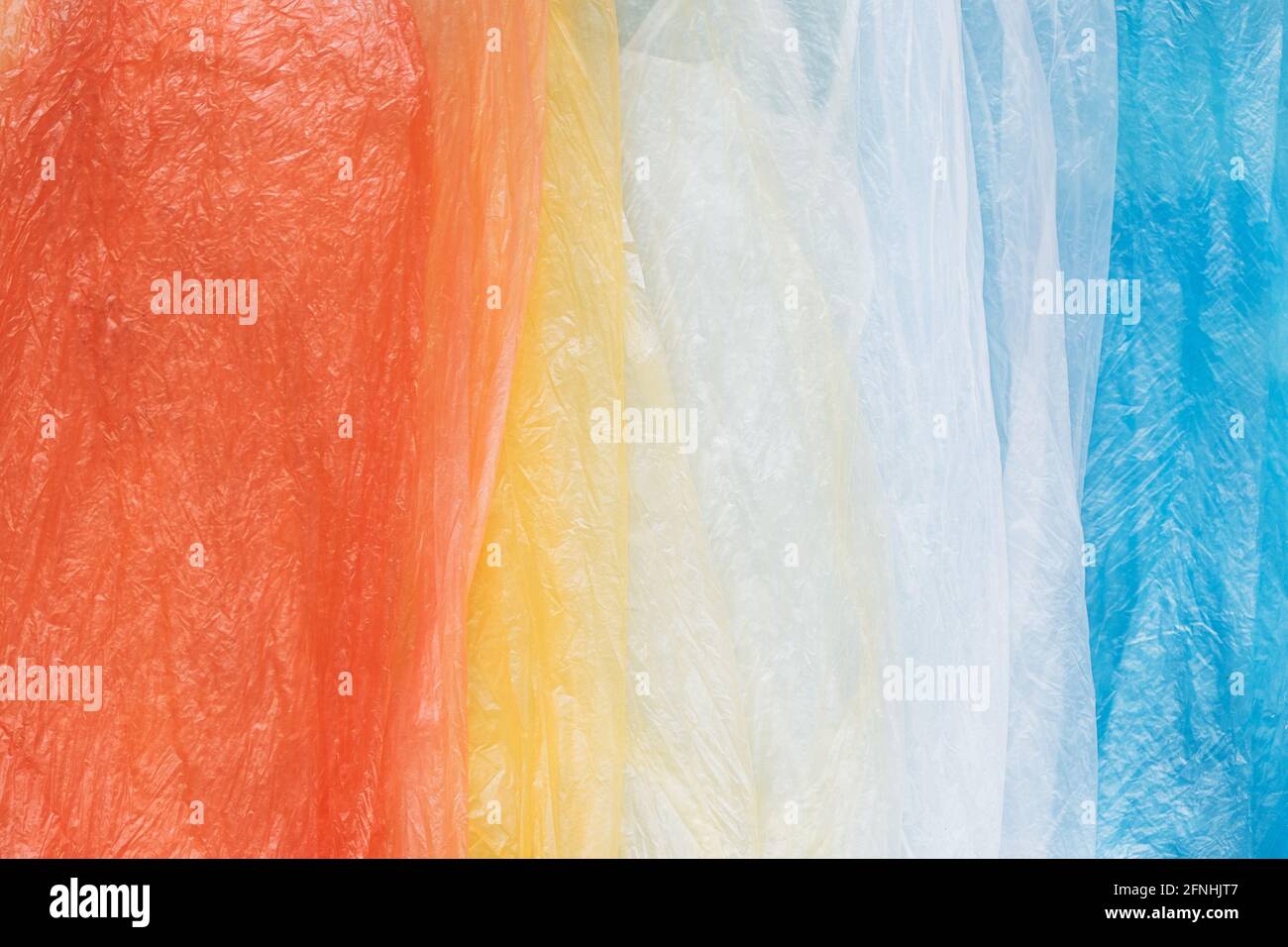 Colorful plastic shopping bags in rainbow layout for eco waste concept