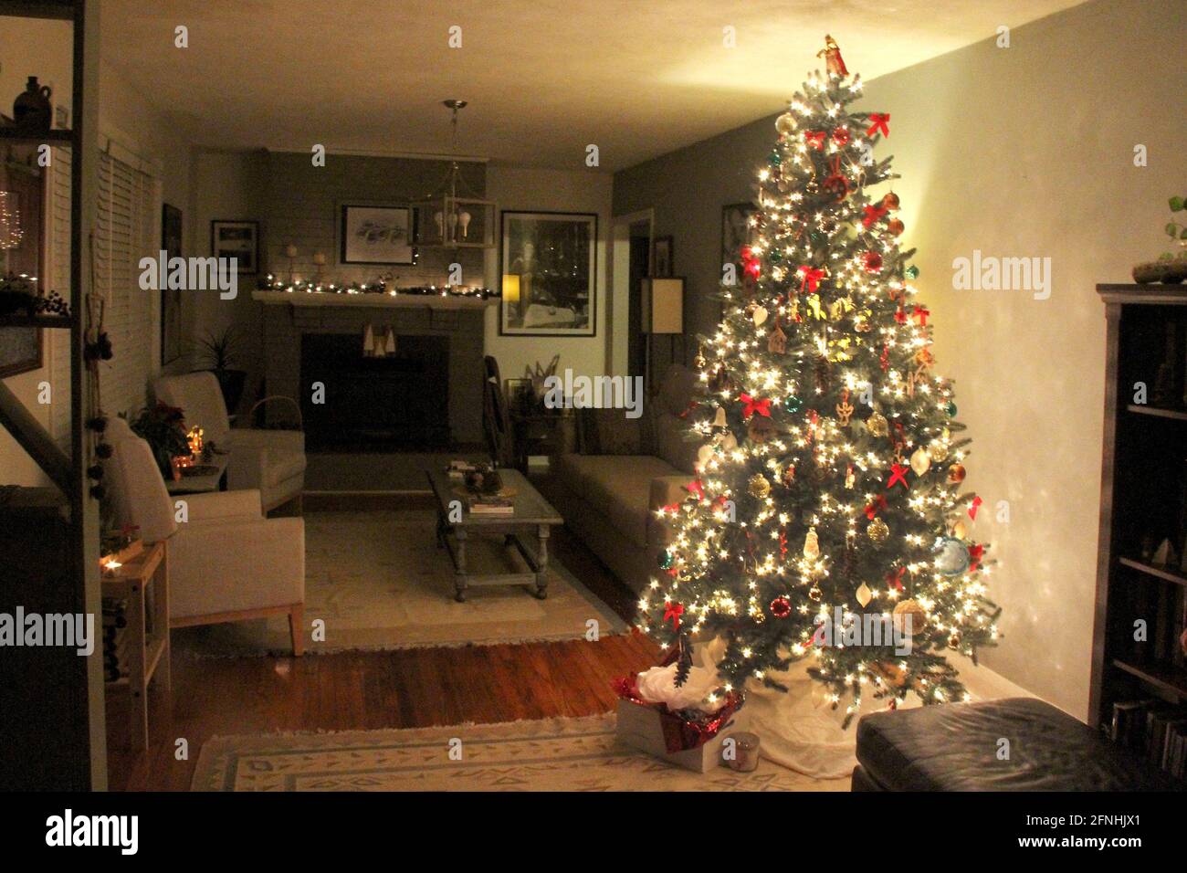 Interior of a family room with illuminated Christmas tree Stock Photo