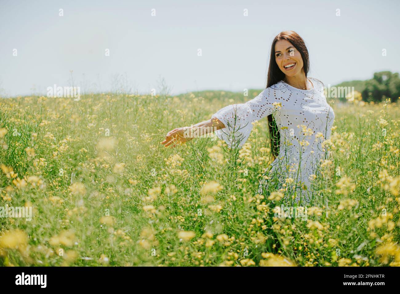 Pretty young woman in the rapeseed field Stock Photo - Alamy