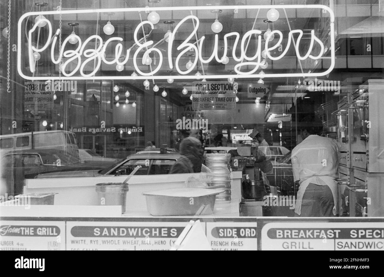 New York City Photo Essay, April 30, 1981- Pizza & Burgers. Reflection of Empire Savings Bank sign in the the window. Stock Photo