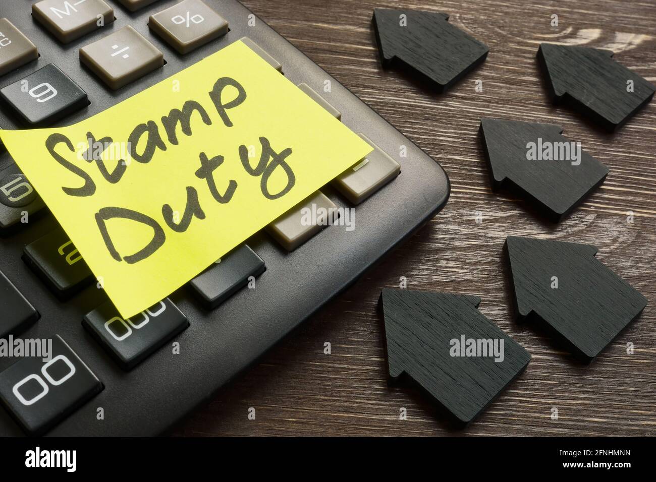 Memo stamp duty land tax on the black calculator Stock Photo - Alamy