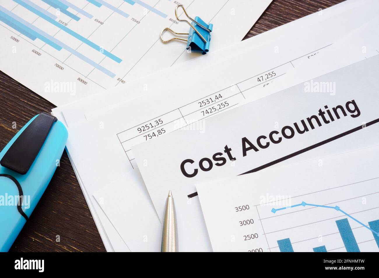 Calculations and cost accounting report with stack of papers. Stock Photo