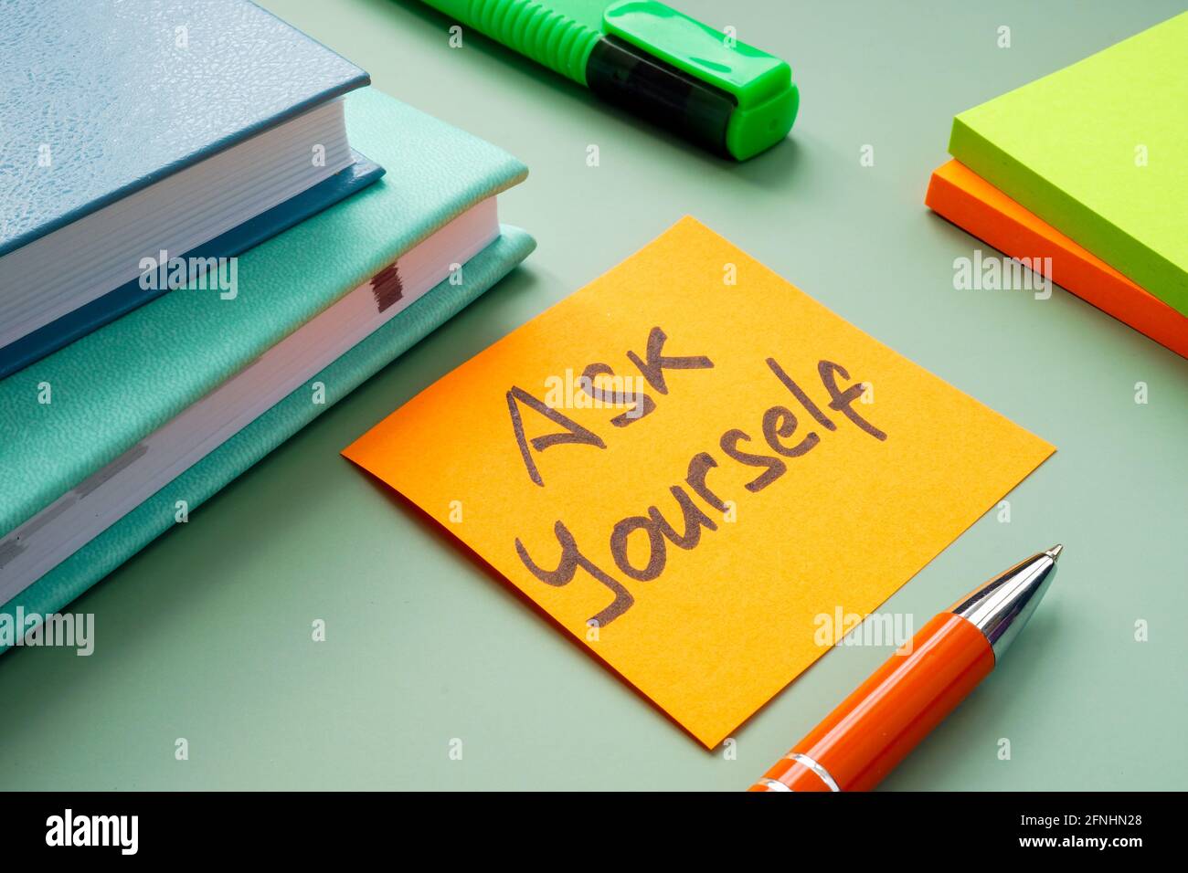 Motivational sign Ask yourself on the workplace. Stock Photo