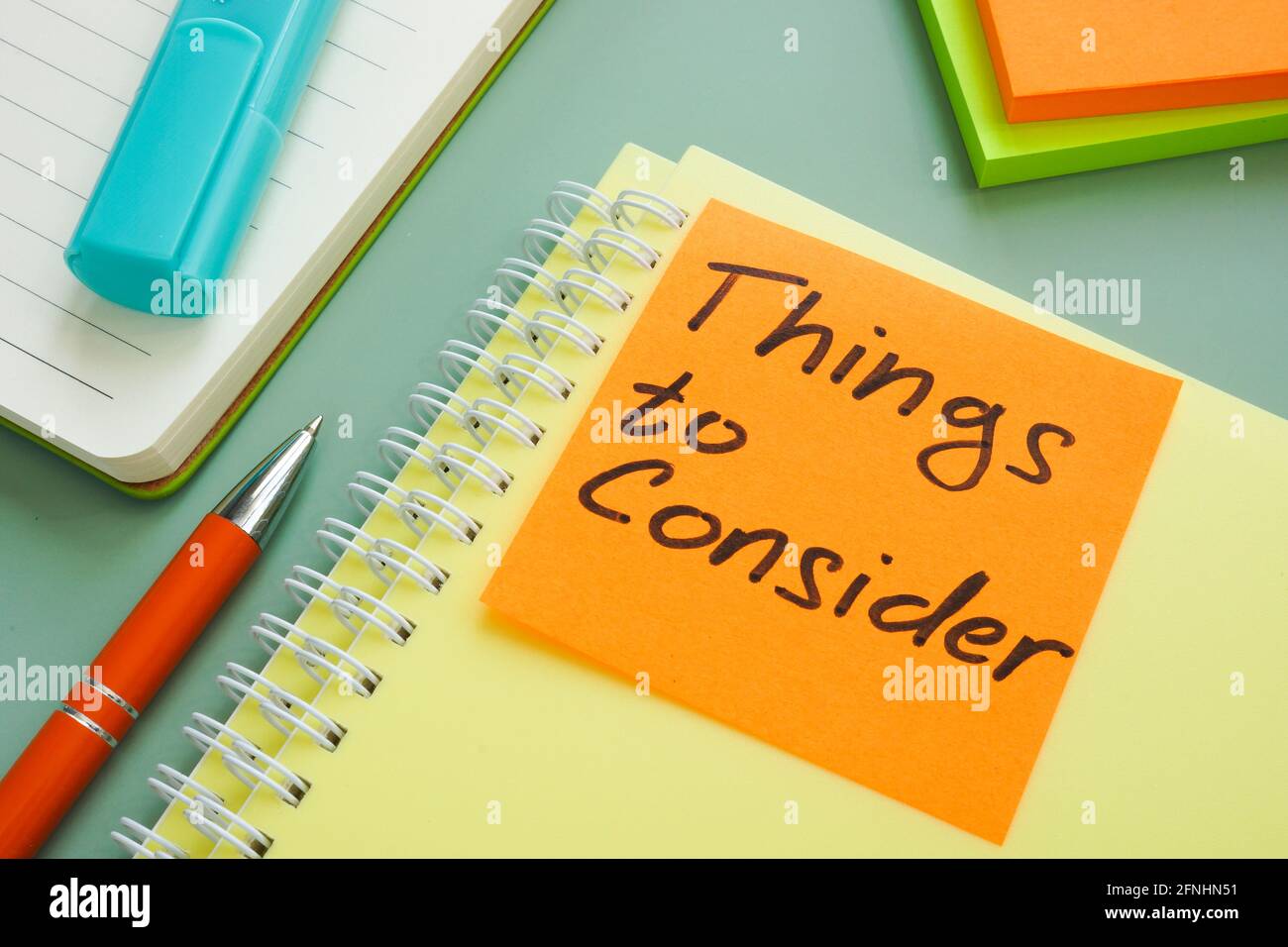 Things to consider memo on the stack of documents. Stock Photo