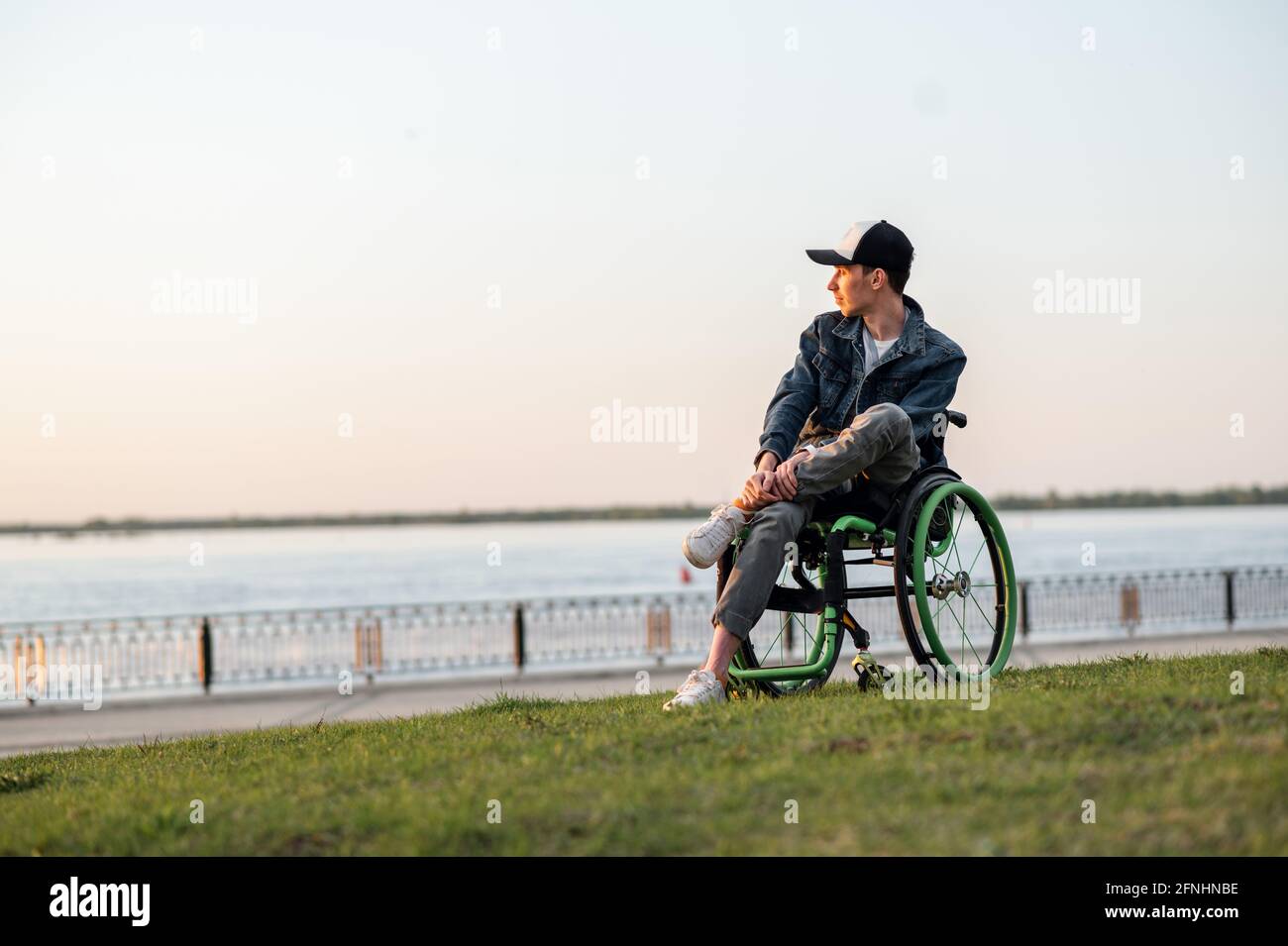 disabled young guy in a wheelchair. Disabled person in a wheelchair for