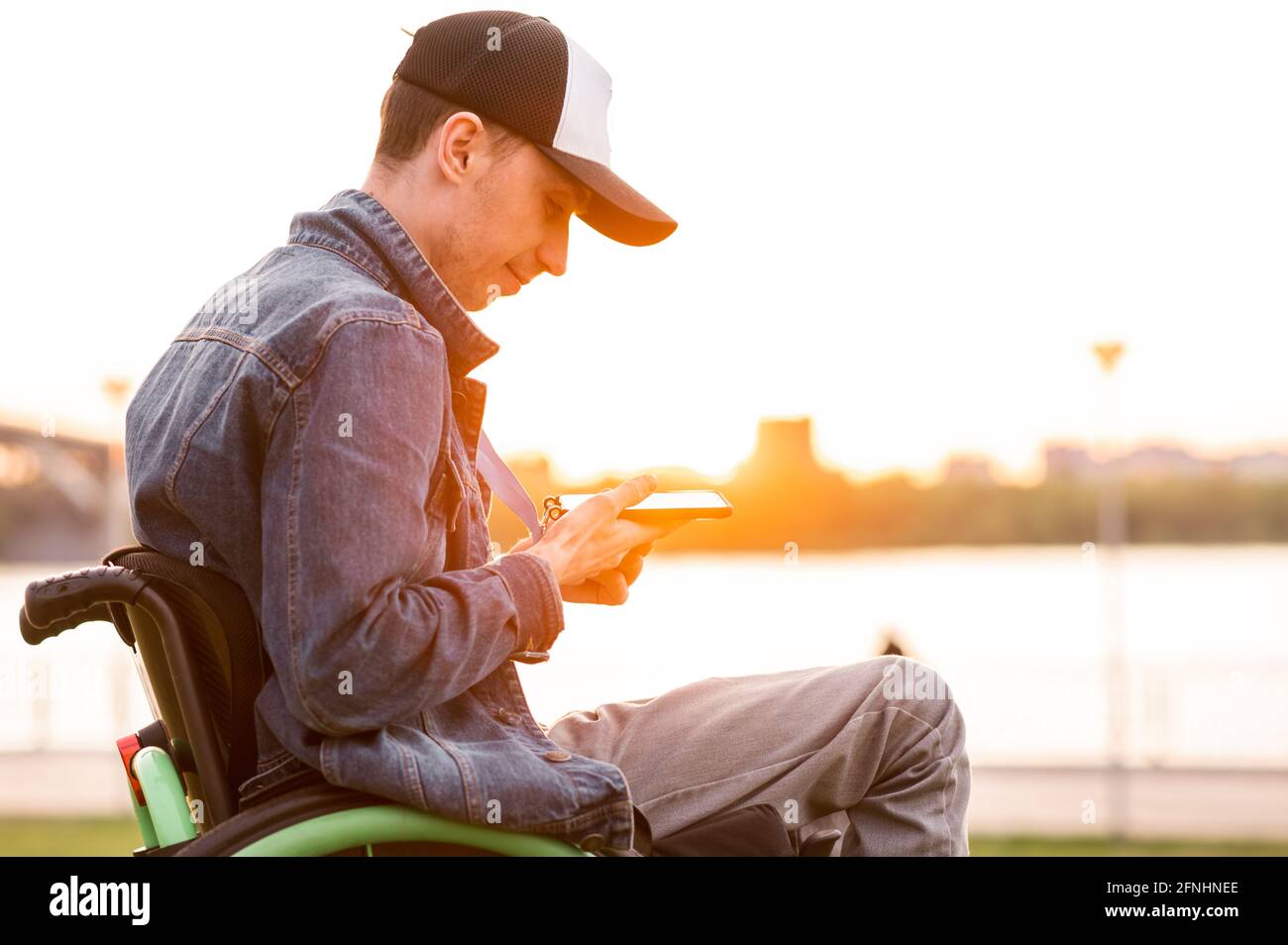 young disabled man in wheelchair walking park Stock Photo Alamy