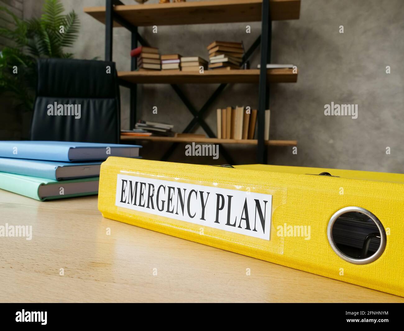 Emergency plan in the yellow folder on the desk. Stock Photo