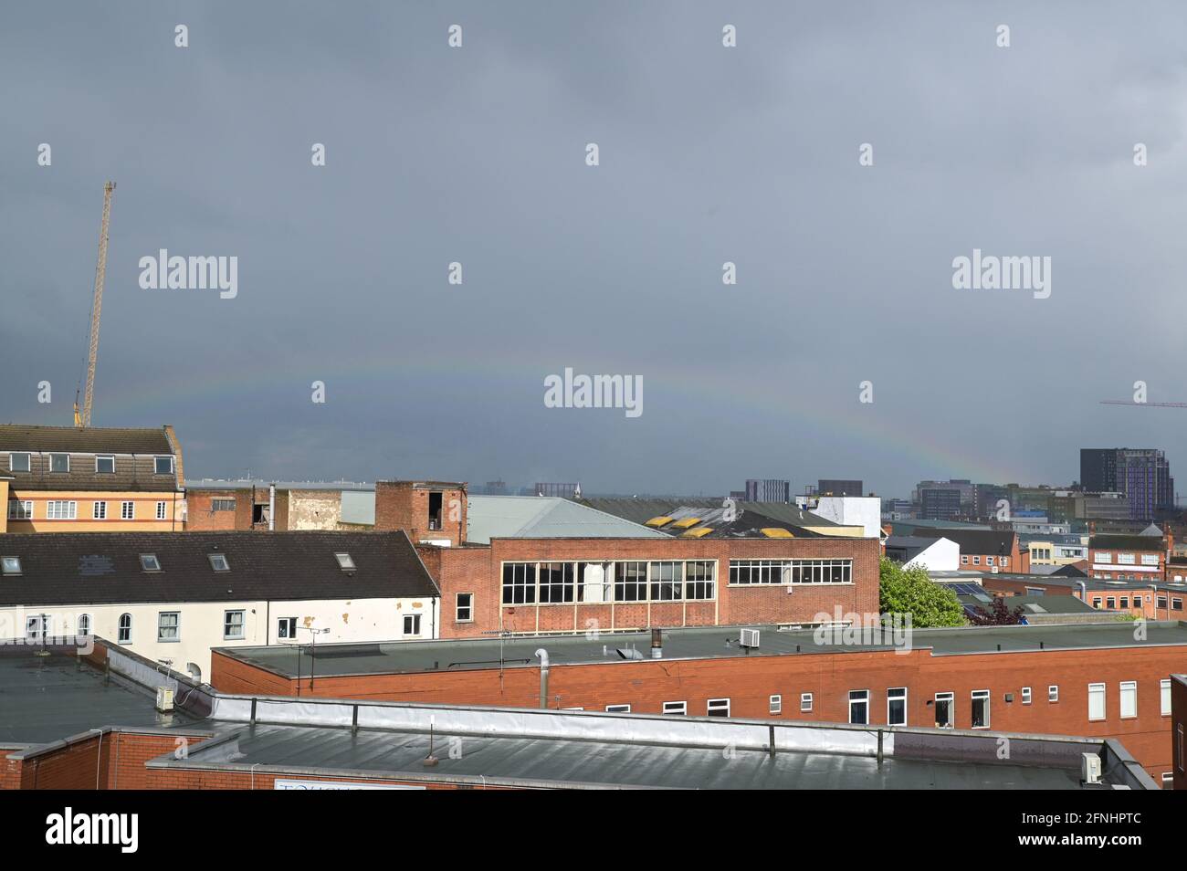 Aston, Birmingham, West Midlands, UK. 17th May 2021. A rare low rainbow formed over the Aston area of Birmingham city centre, England this afternoon as heavy rain hit many parts of the country. The bow was unusually low and started from the faculty building at the right of the image. Pic by Sam Holiday/Alamy Live News Stock Photo