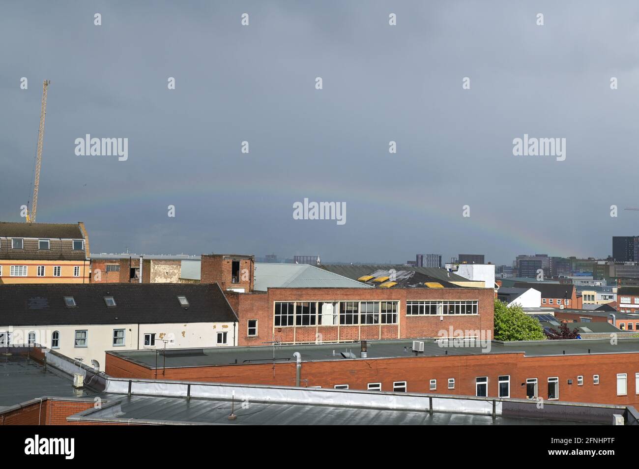 Aston, Birmingham, West Midlands, UK. 17th May 2021. A rare low rainbow formed over the Aston area of Birmingham city centre, England this afternoon as heavy rain hit many parts of the country. The bow was unusually low and started from the faculty building at the right of the image. Pic by Sam Holiday/Alamy Live News Stock Photo