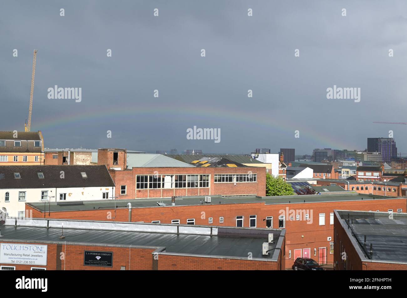 Aston, Birmingham, West Midlands, UK. 17th May 2021. A rare low rainbow formed over the Aston area of Birmingham city centre, England this afternoon as heavy rain hit many parts of the country. The bow was unusually low and started from the faculty building at the right of the image. Pic by Sam Holiday/Alamy Live News Stock Photo