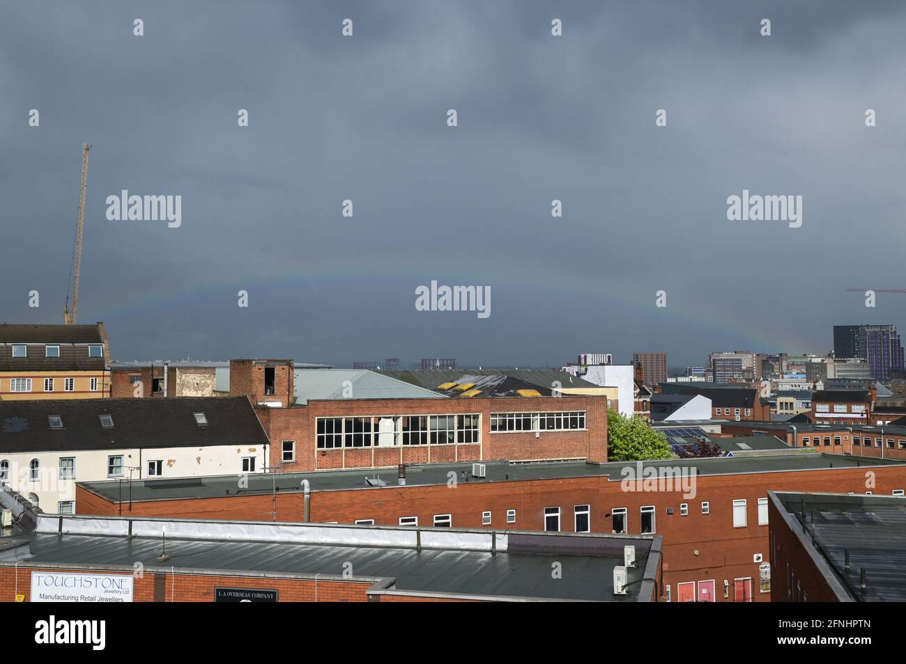 Aston, Birmingham, West Midlands, UK. 17th May 2021. A rare low rainbow formed over the Aston area of Birmingham city centre, England this afternoon as heavy rain hit many parts of the country. The bow was unusually low and started from the faculty building at the right of the image. Pic by Sam Holiday/Alamy Live News Stock Photo