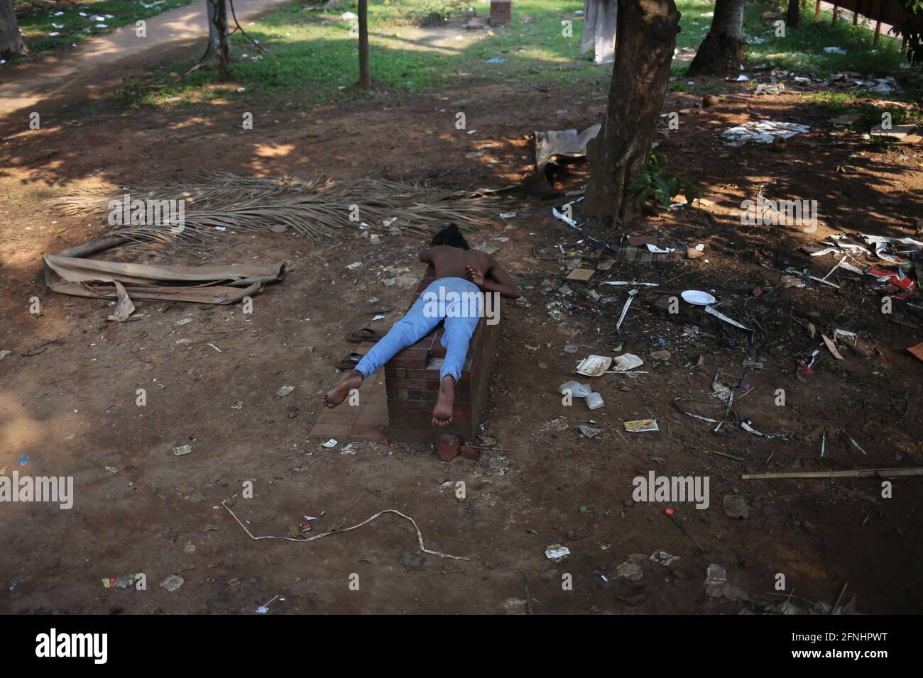 Dhaka, Bangladesh. 17th May, 2021. A homeless person is sleeping on a bench of a park during the 2nd wave of COVID-19 pandemic in Dhaka, Bangladesh on May 17, 2021. Credit: Md. Rakibul Hasan/ZUMA Wire/Alamy Live News Stock Photo