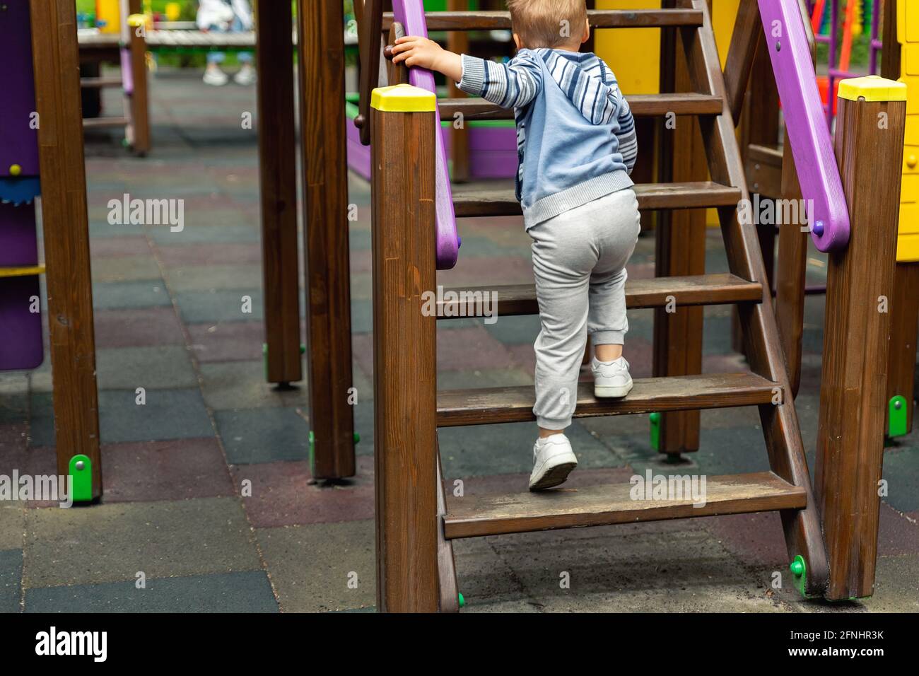 Back view cute adorable caucasian blond little toddler boy kid having ...