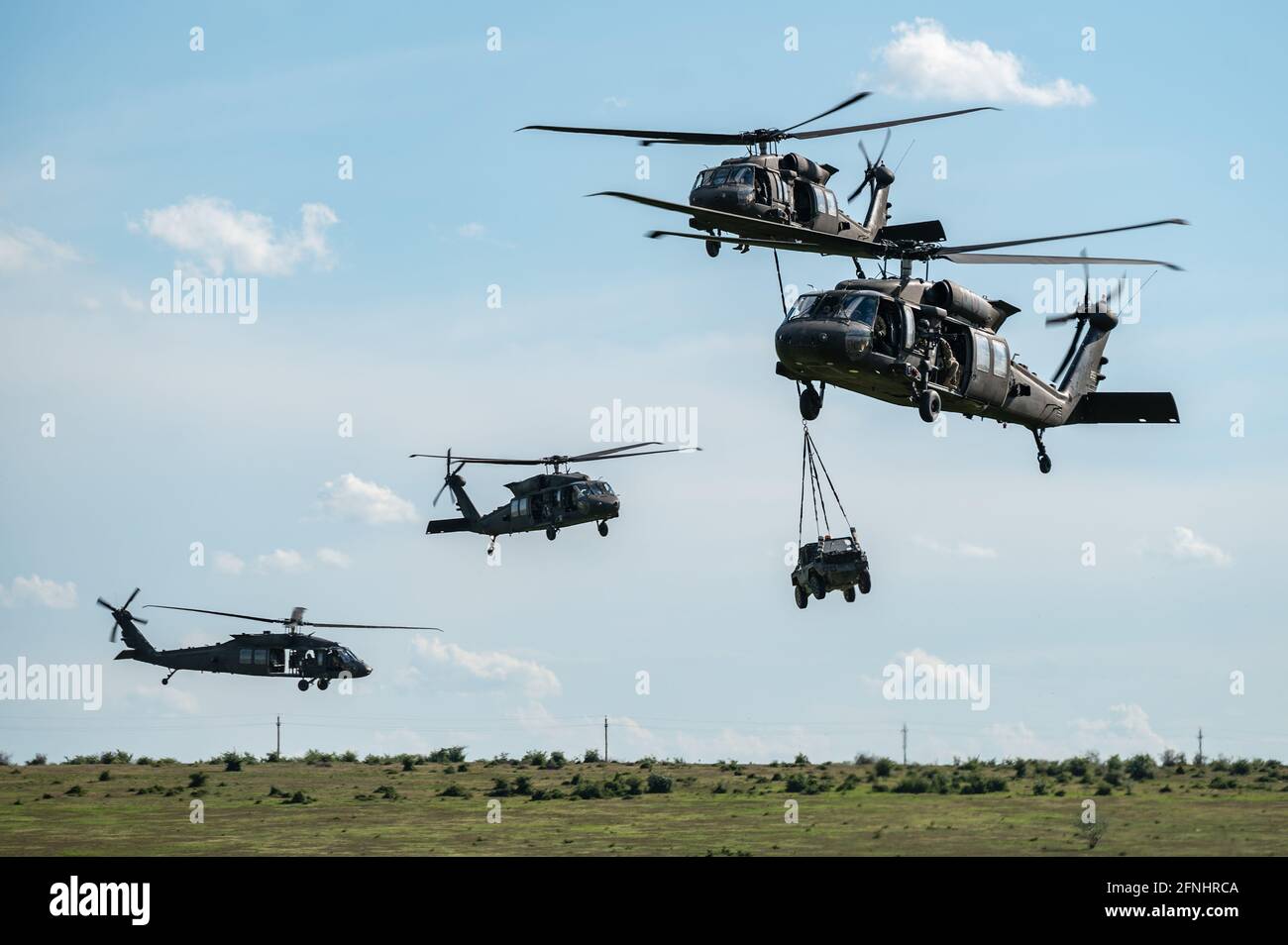 U.S. UH-60 Black Hawk helicopters from 3rd Battalion, 1st Aviation Regiment, 1st CAB conduct sling load operations with equipment from the Dutch 11th Air Assault Brigade of the Royal Netherlands Arm during exercise Falcon Response 21 at Mihail Kogalniceanu Air Base, May 15, 2021 in Mihail Kogalniceanu, Romania. Stock Photo