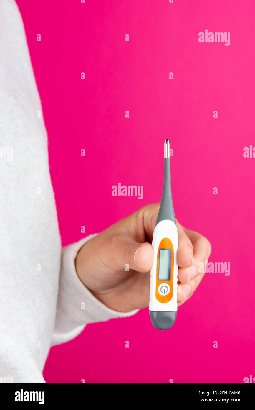 Medical thermometer in hand. Medical device for measuring body
