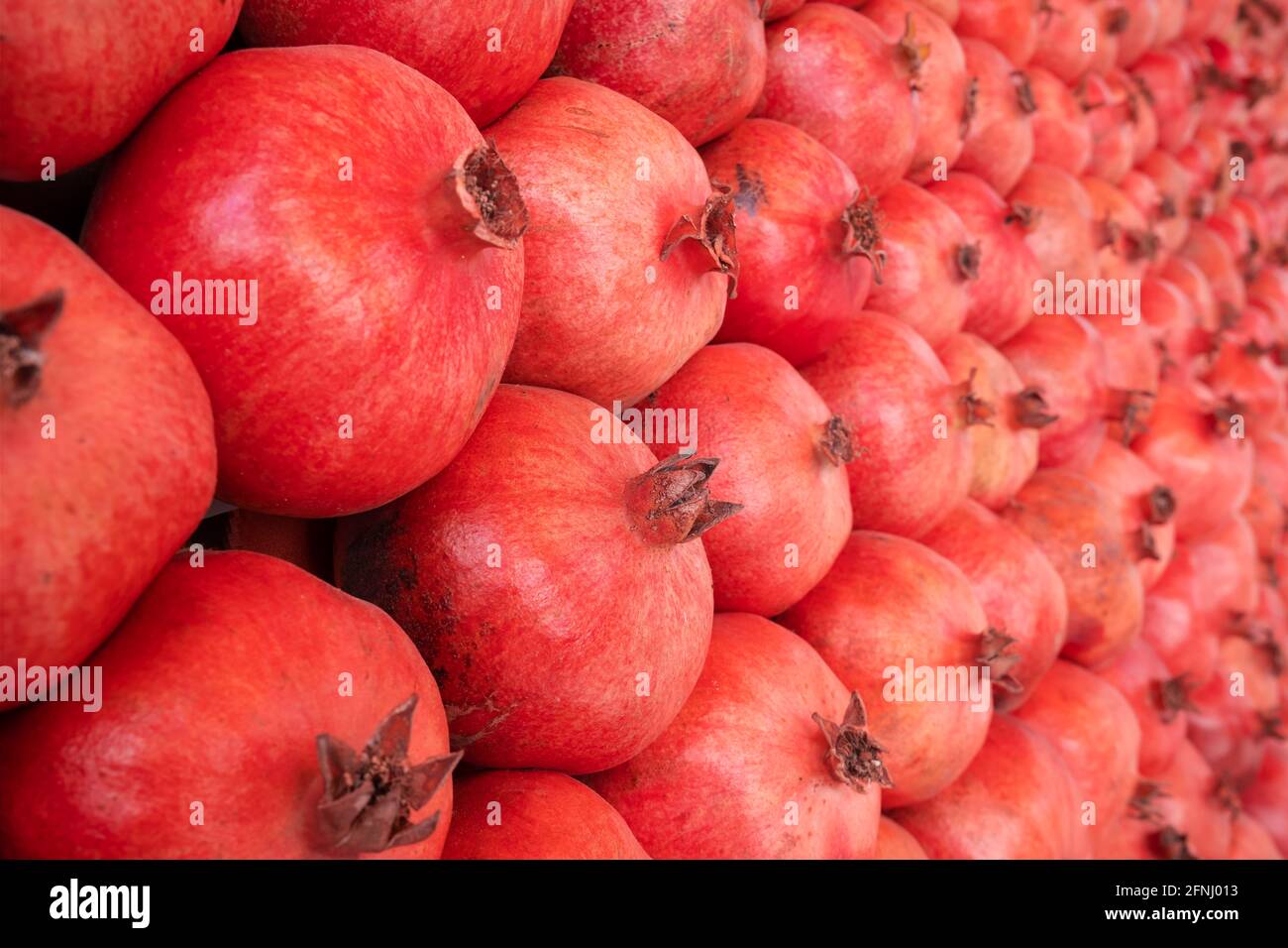 Group of pomegranates closeup, selective focus. Stock Photo