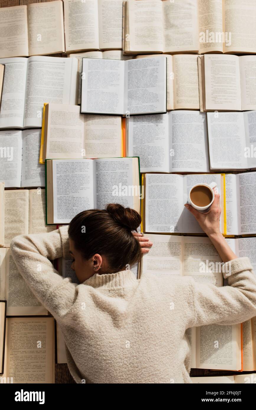 Young woman sleeping on stack of books hi-res stock photography and ...