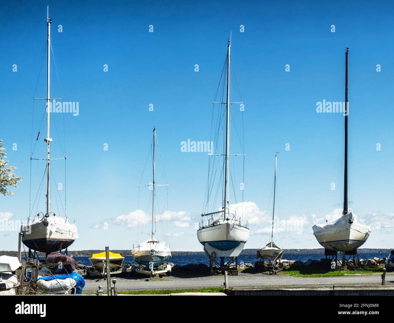 Sailboats moored on the shore of Lake Ontario at Navy Point Marine in Sackets Harbor, New York Stock Photo