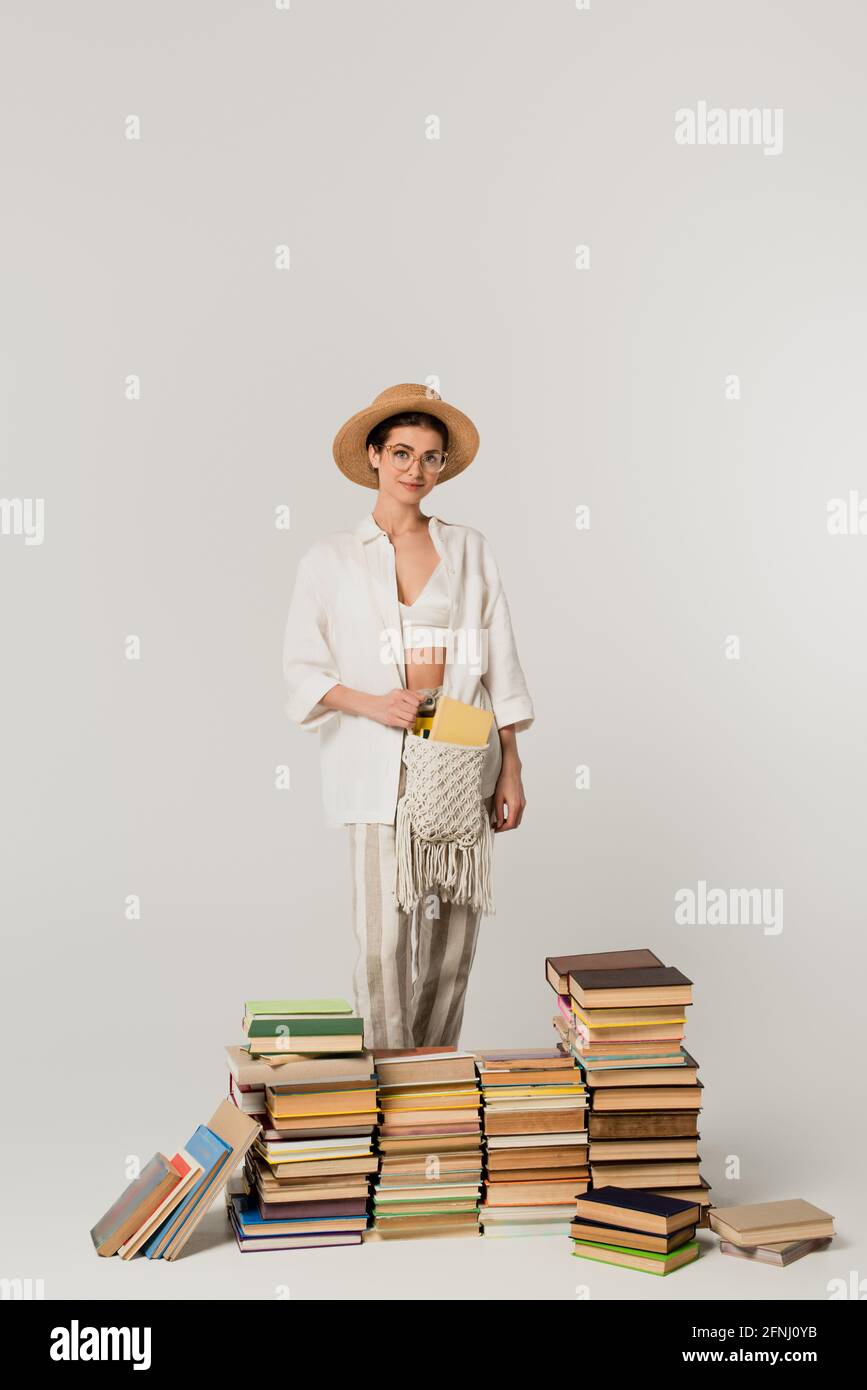 Woman standing on pile books hi-res stock photography and images - Alamy