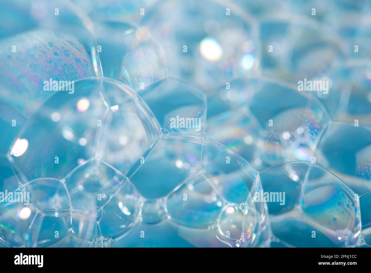 Foam background. Soap bubbles close up on blue background. Stock Photo