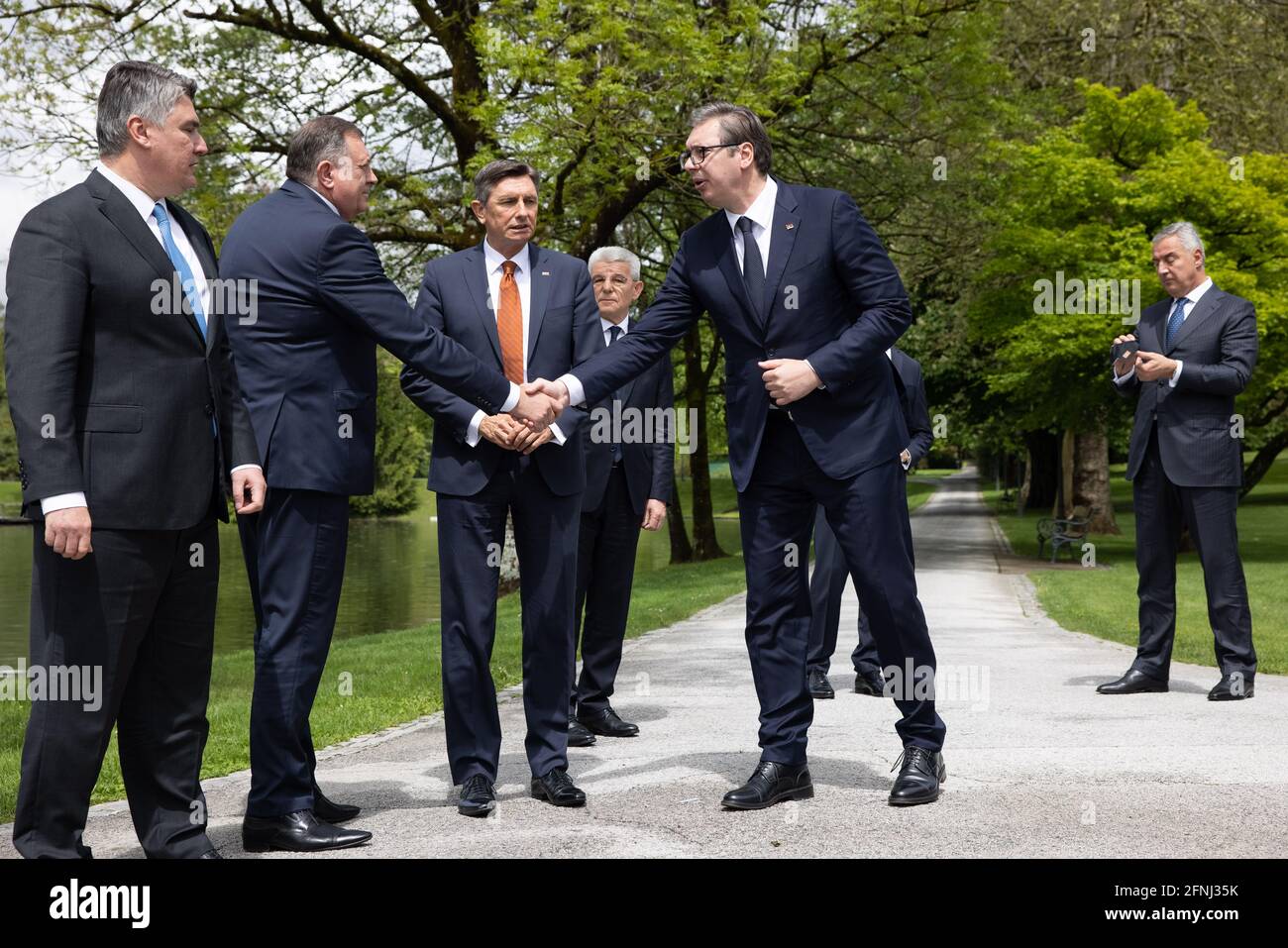 Kranj, Slovenia. 17th May, 2021. Serbian president Aleksandar Vucic (R) shakes hands with Milorad Dodik of Bosnia and Herzegovina at the Brdo-Brijuni Process summit. Slovenian president Borut Pahor hosted a summit of the Brdo-Brijuni Process in Brdo pri Kranju where he met the presidents of Albania, Croatia, Serbia, North Macedonia, Montenegro, Kosovo and the presiding trio of Bosnia and Herzegovina, marking the 10th anniversary of the initiative. (Photo by Luka Dakskobler/SOPA Images/Sipa USA) Credit: Sipa USA/Alamy Live News Stock Photo