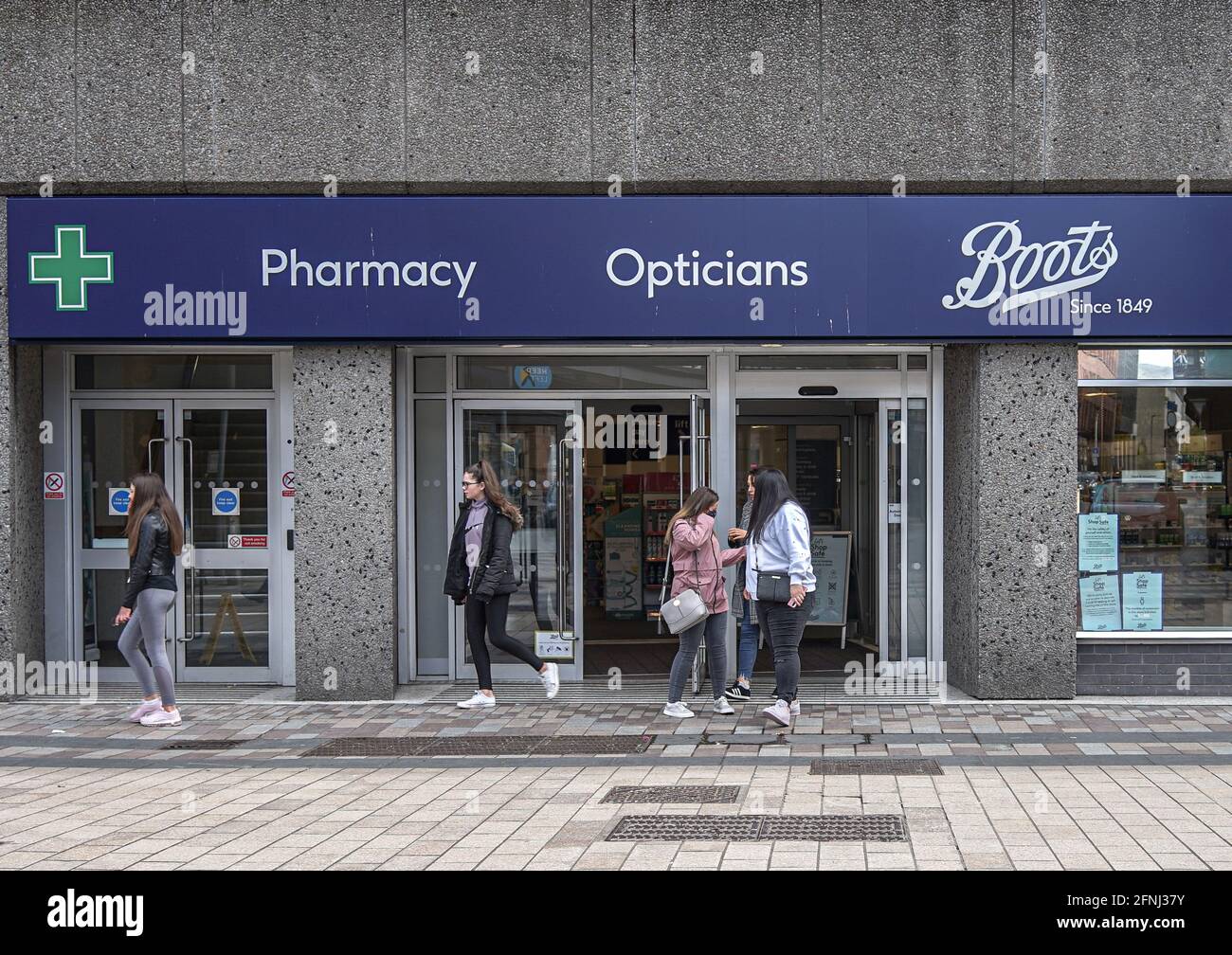Belfast, UK. 09th May, 2021. Customers leave Boots Pharmacy. Credit