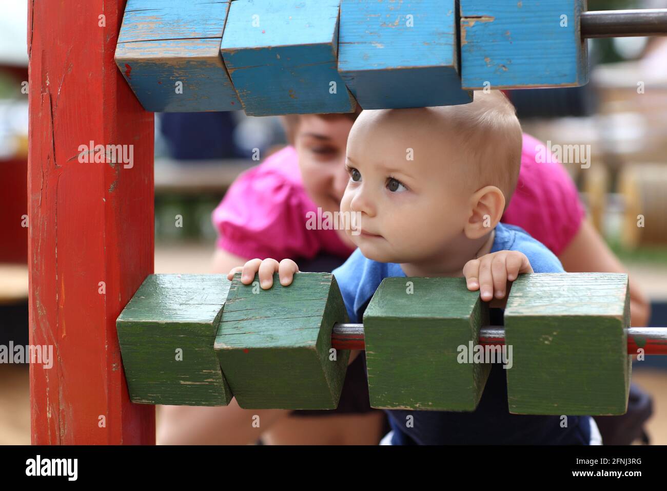 curious-child-is-looking-out-from-the-playground-s-wall-stock-photo-alamy