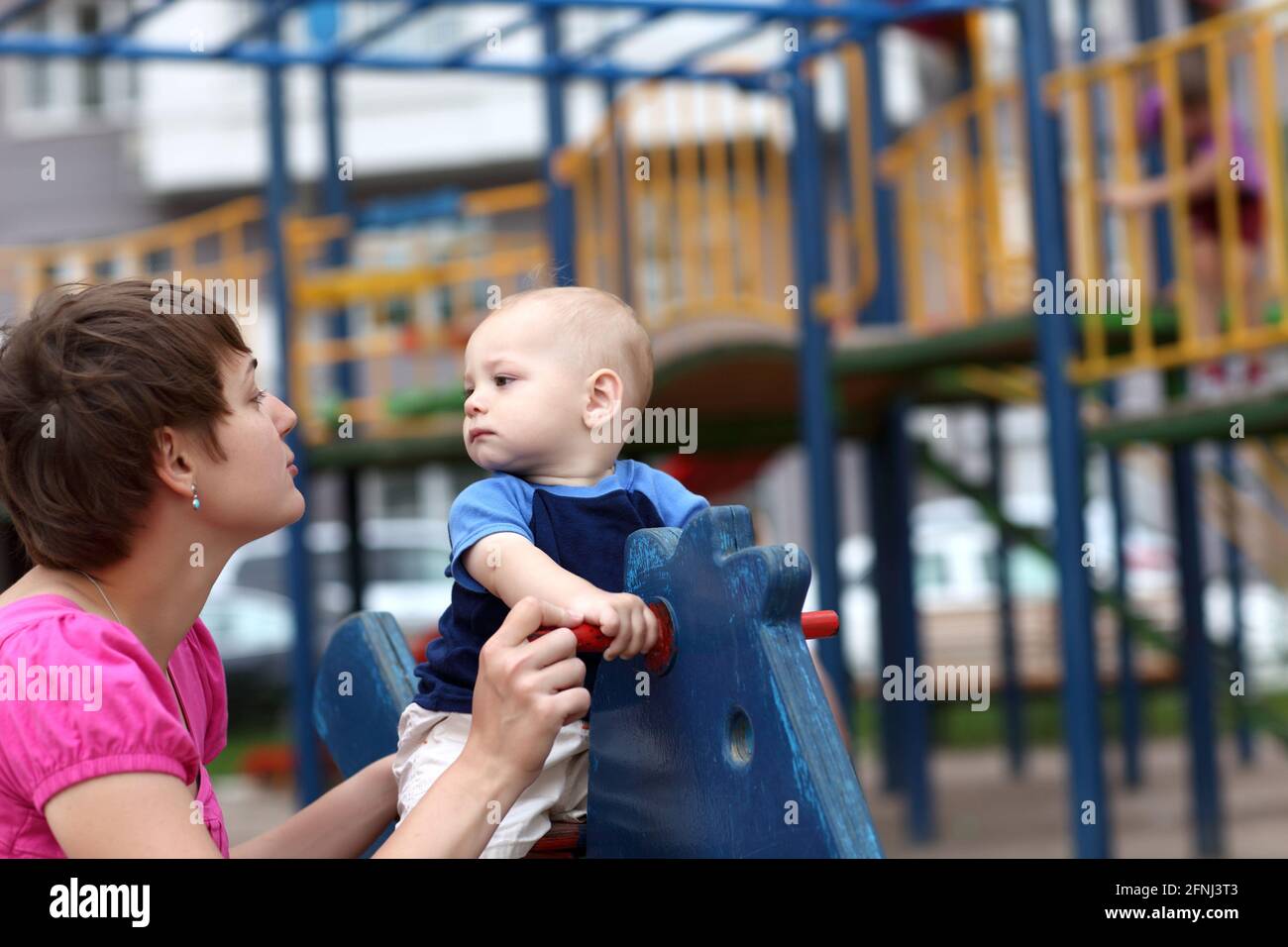 Child with his mother are playing at playground Stock Photo - Alamy