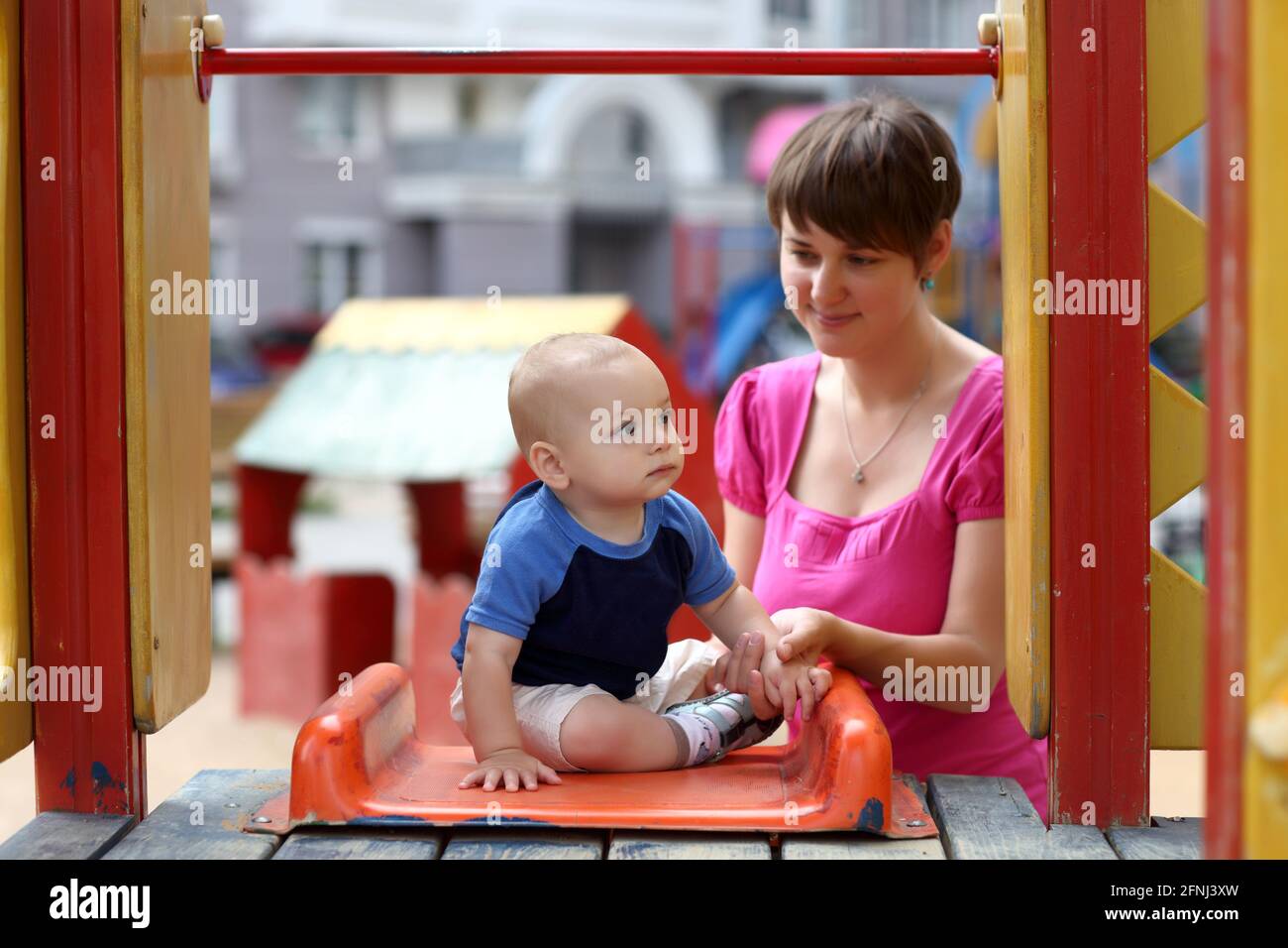 Little child is sitting on a slide at playground Stock Photo - Alamy