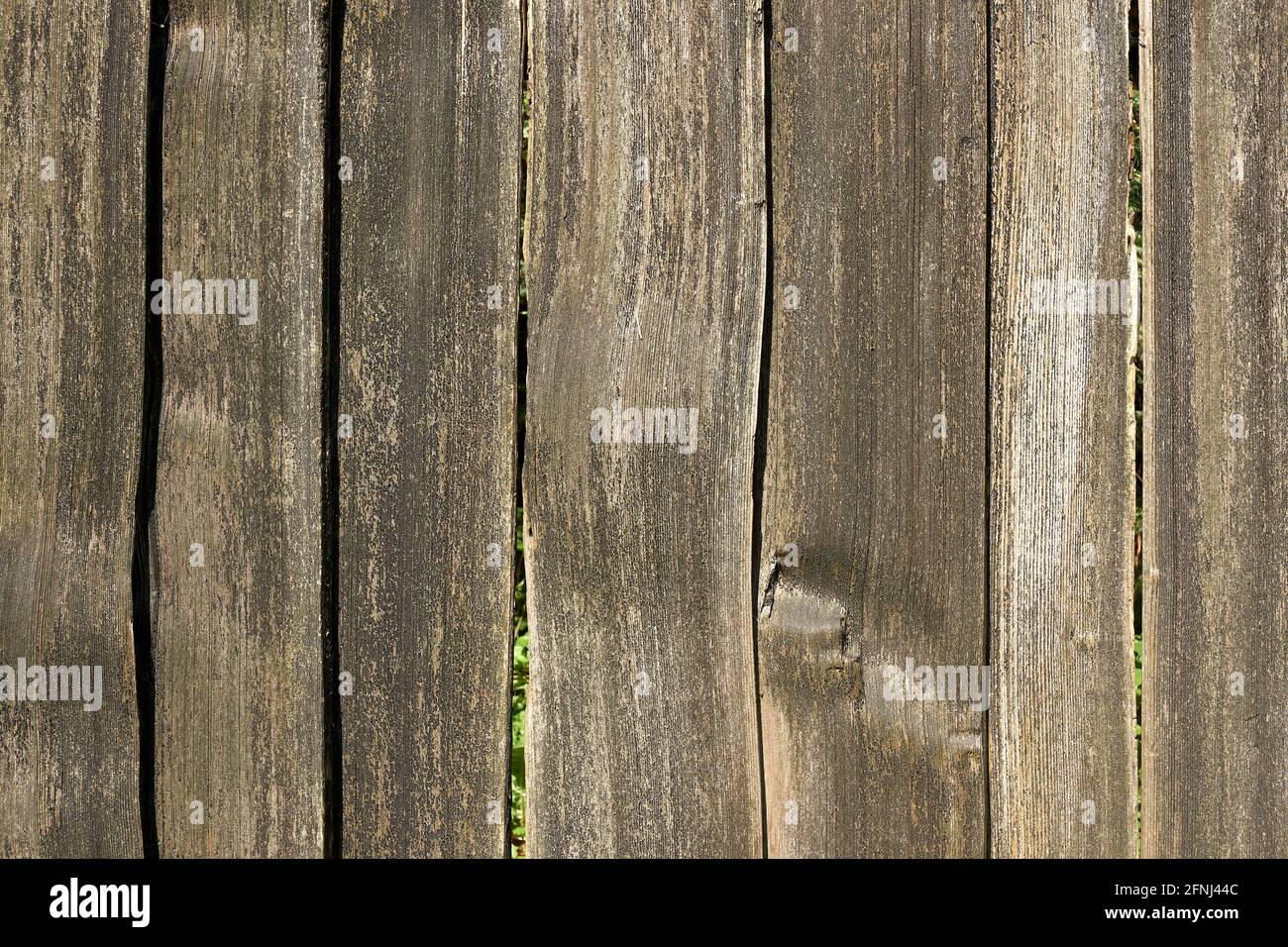 Closeup of wooden fence made of rough wood planks Stock Photo