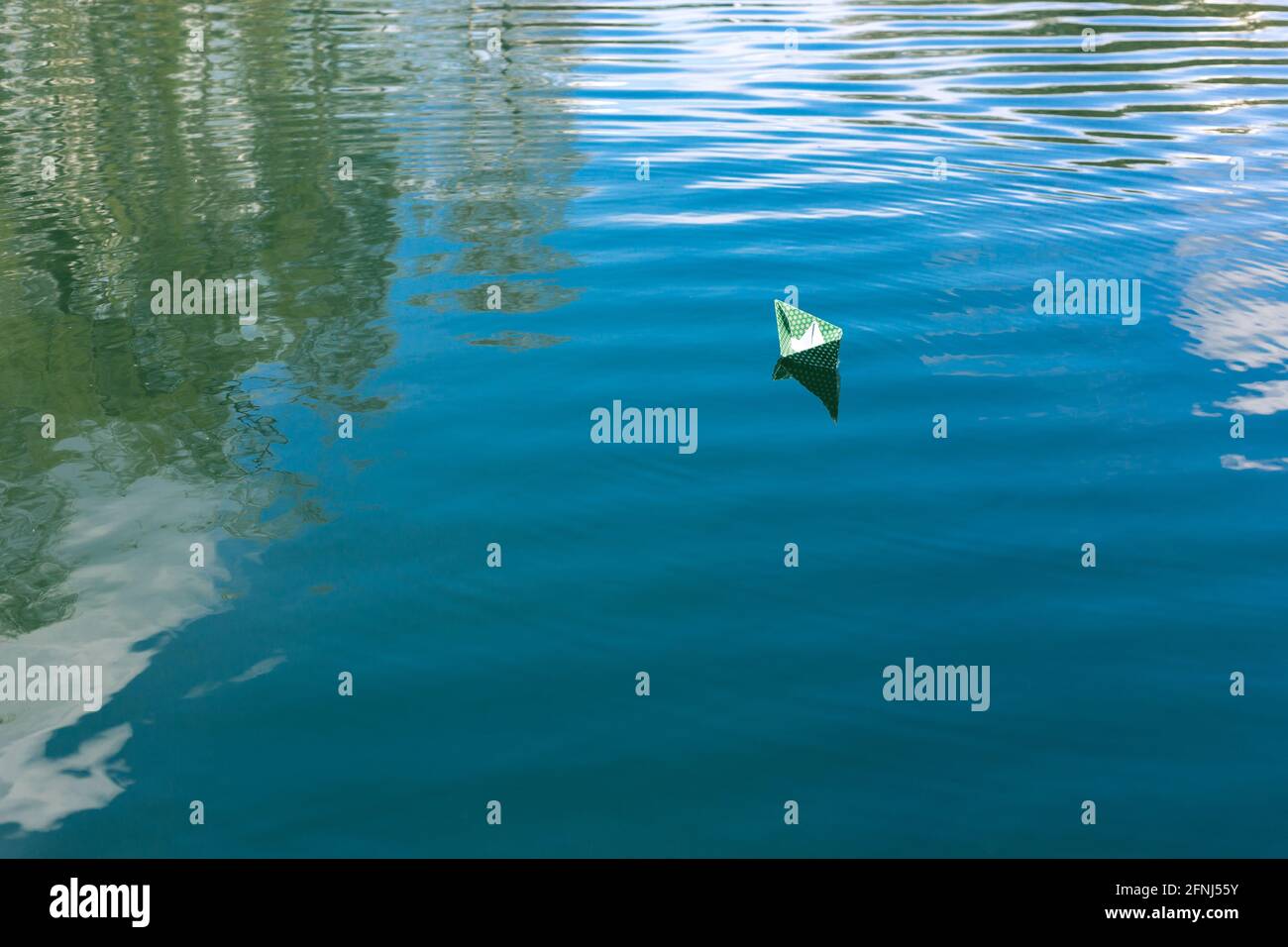 White paper skiffs float on water. Origami Stock Photo Alamy