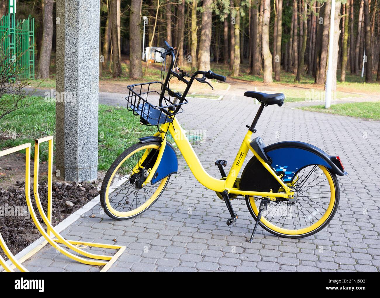 Yellow rental bike stands near the bike parking Stock Photo