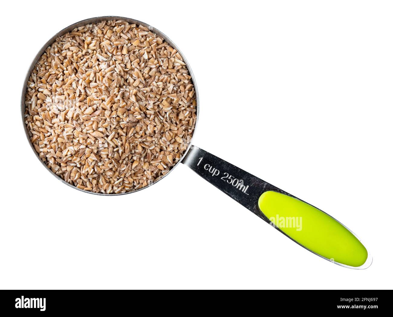 top view of crushed groats of Emmer farro hulled wheat in measuring cup cutout on white background Stock Photo