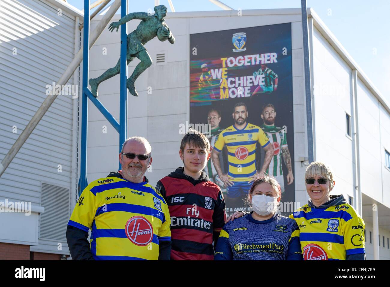 Warrington, UK. 17th May, 2021. Warrington Wolves fans pose for photographs in front of the Brian Bevan statue in Warrington, United Kingdom on 5/17/2021. (Photo by Simon Whitehead/News Images/Sipa USA) Credit: Sipa USA/Alamy Live News Stock Photo