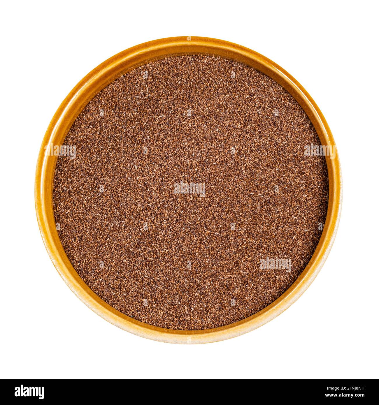 top view of wholegrain teff seeds in round ceramic bowl cutout on white background Stock Photo
